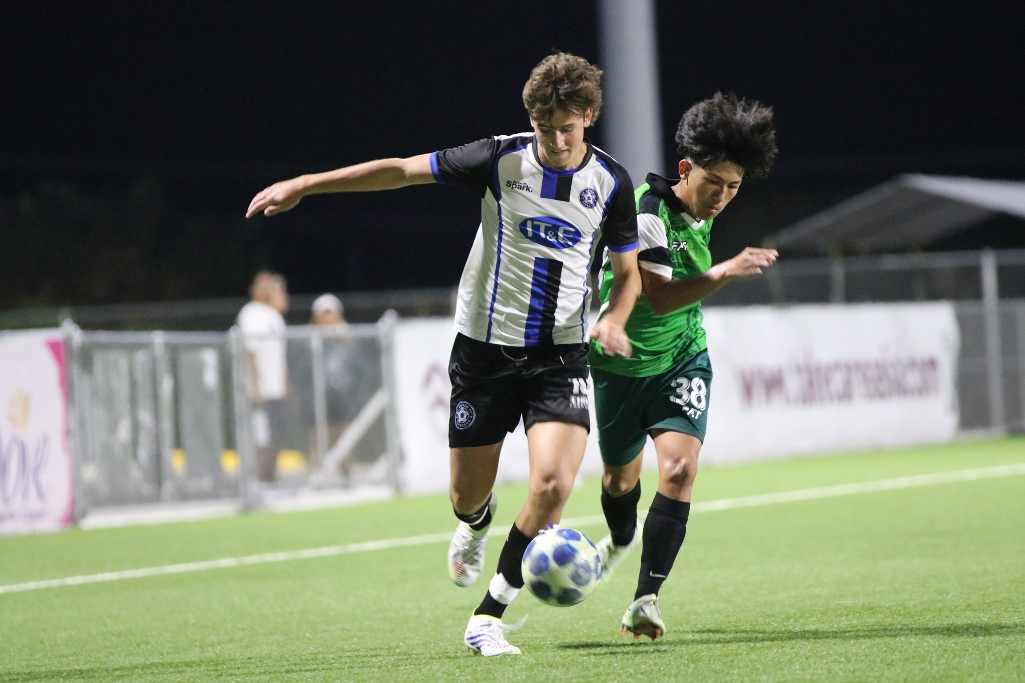 MPU's Dylan Mister battles a Tan Holdings player for the possession in a Marianas Soccer League 1 game at the NMI Soccer Training Center in Koblerville.