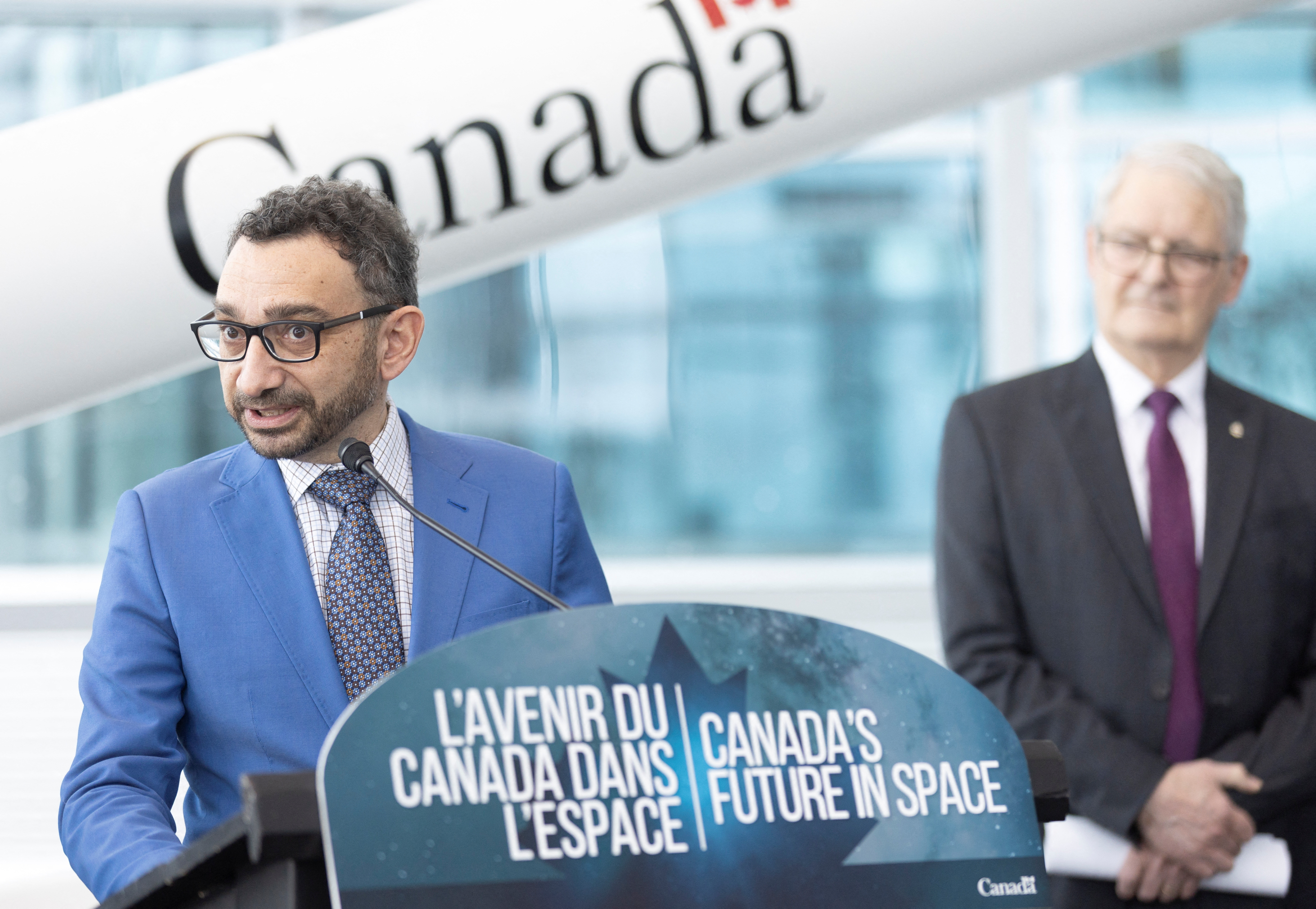 FILE PHOTO: Canada's Minister of Transport Omar Alghabra speaks as member of parliament Marc Garneau looks on during an announcement supporting Canada commercial space launches at the Canadian Space Agency in Longueuil, Quebec, Canada, January 20, 2023. REUTERS/Christinne Muschi