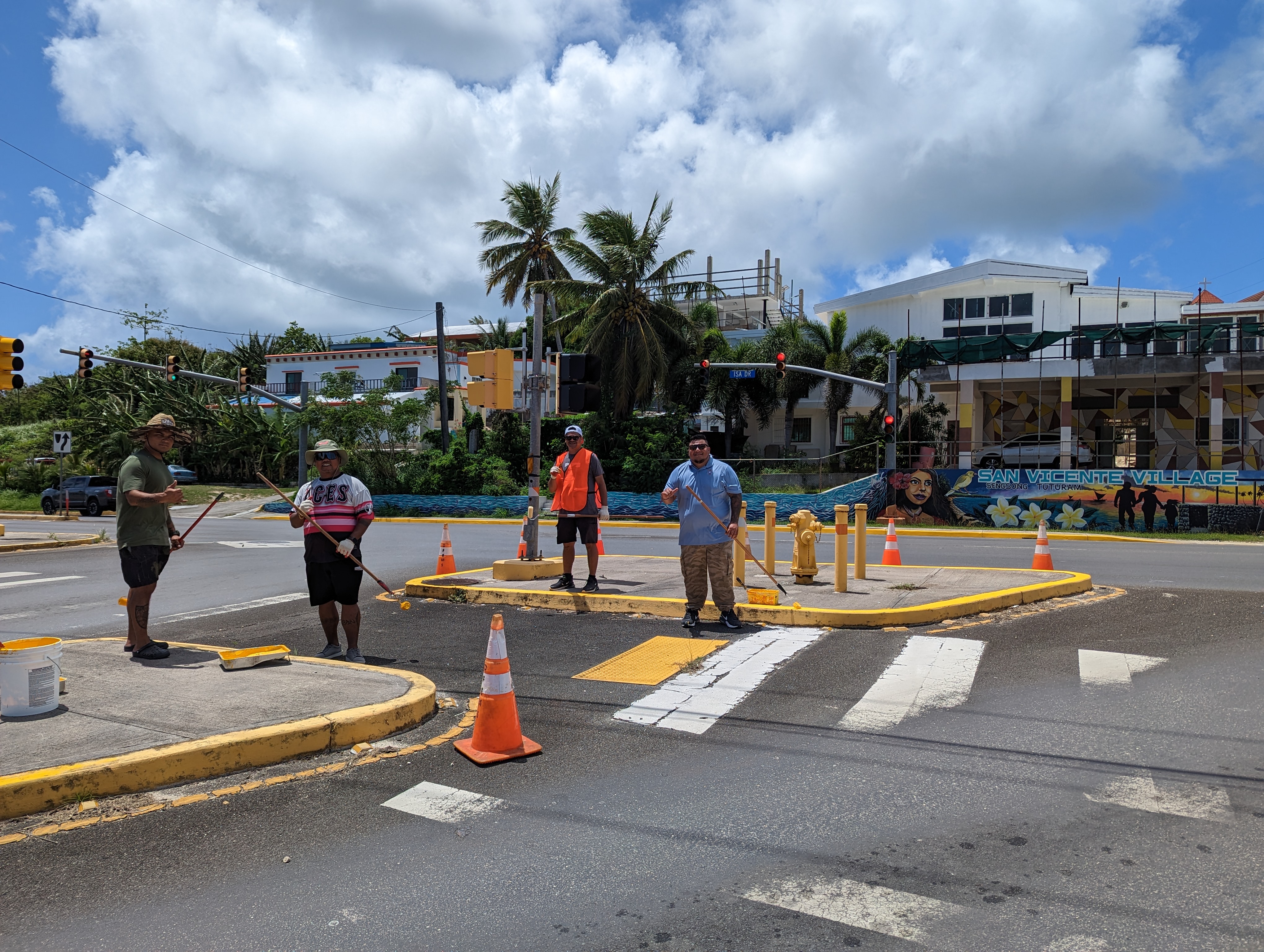 DFEMS Lt. Paul Manglona, former Rep. Angel Demapan, Reps. Roy Ada and Thomas Manglona repaint traffic islands at the San Vicente intersection on Thursday.