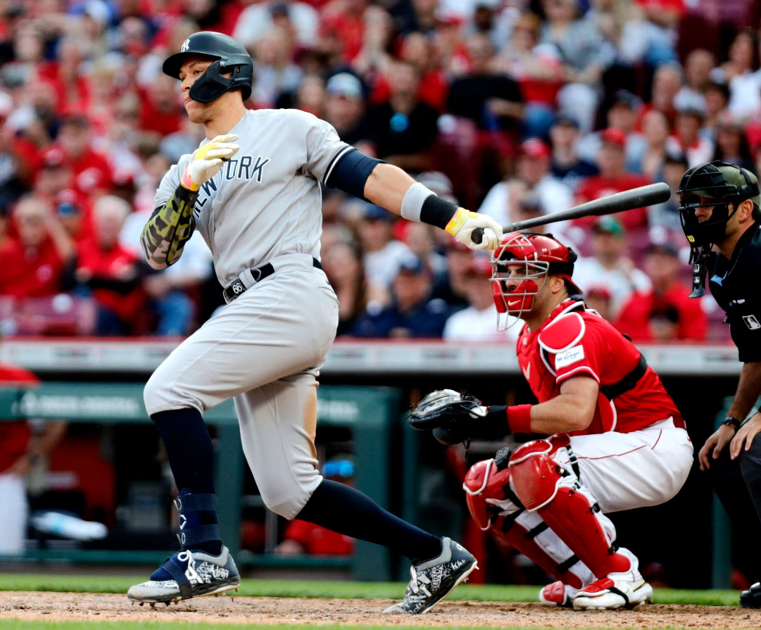 New York Yankees designated hitter Aaron Judge (99) hits an RBI single against the Cincinnati Reds during the tenth inning at Great American Ball Park in Cincinnati, Ohio, May 20, 2023.