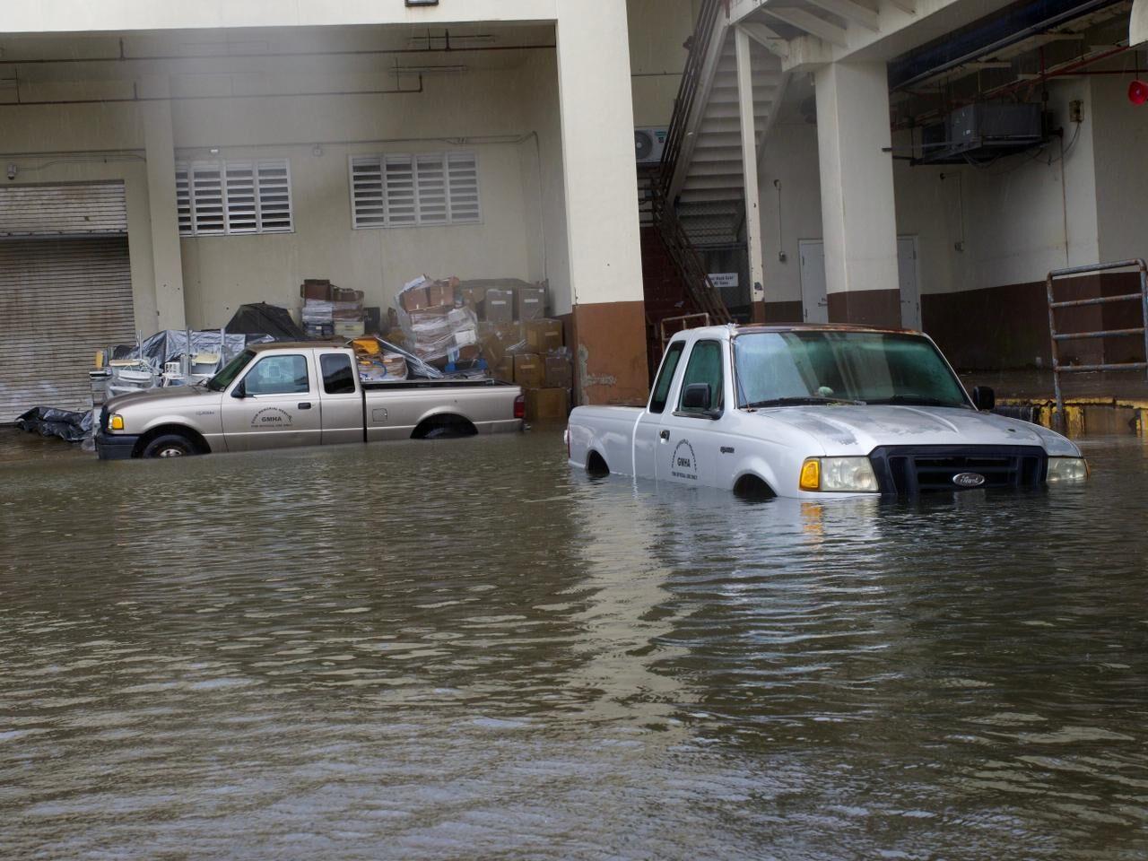 A flood of standing water goes about halfway up trucks parked at the Guam Memorial Hospital as a result of Supertyphoon Mawar, as seen Thursday in Tamuning. 