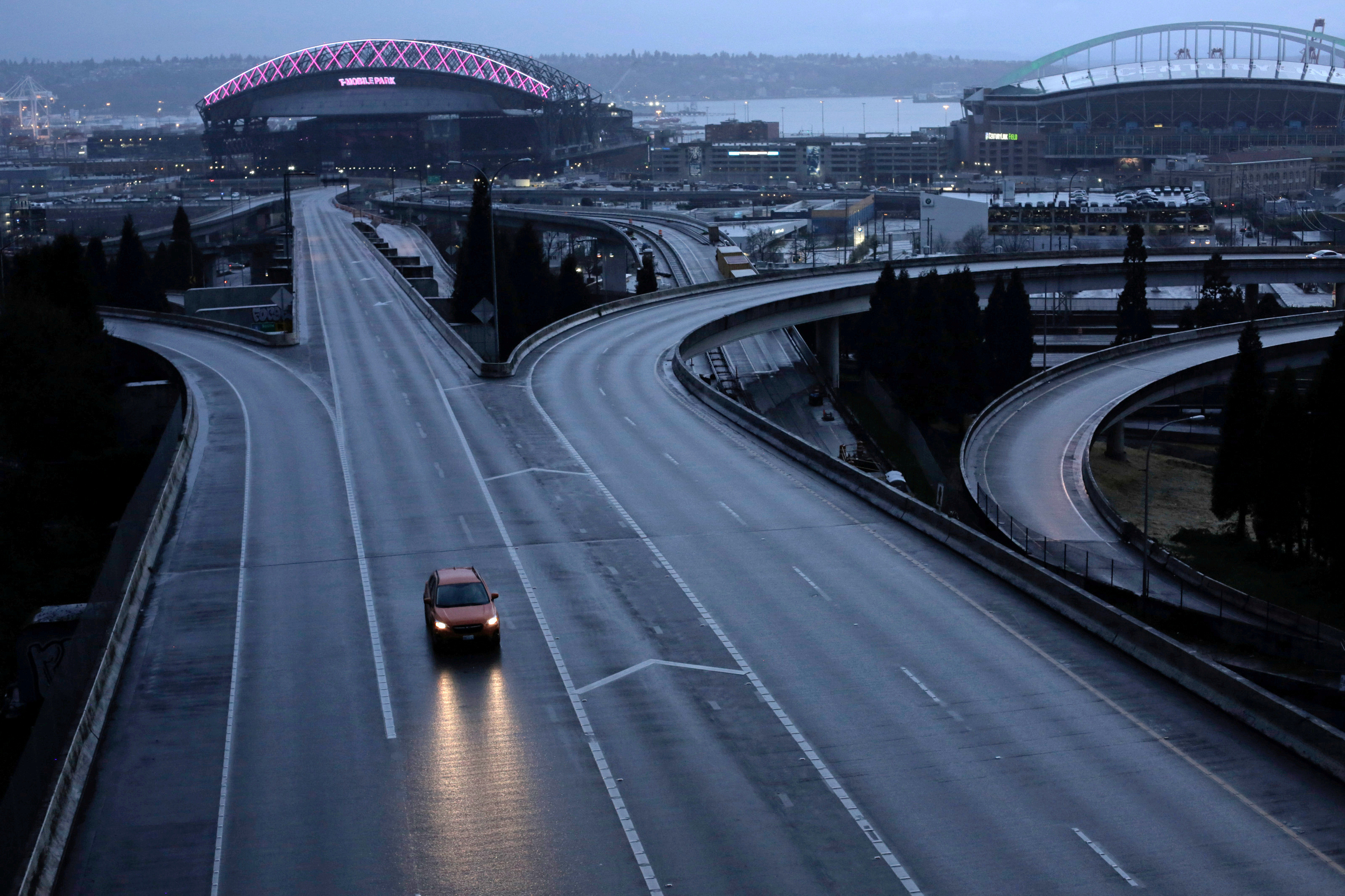 FILE PHOTO: A car moves along an empty highway during the coronavirus disease (COVID-19) outbreak in Seattle, Washington, U.S. March 30, 2020. REUTERS/David Ryder/File Photo