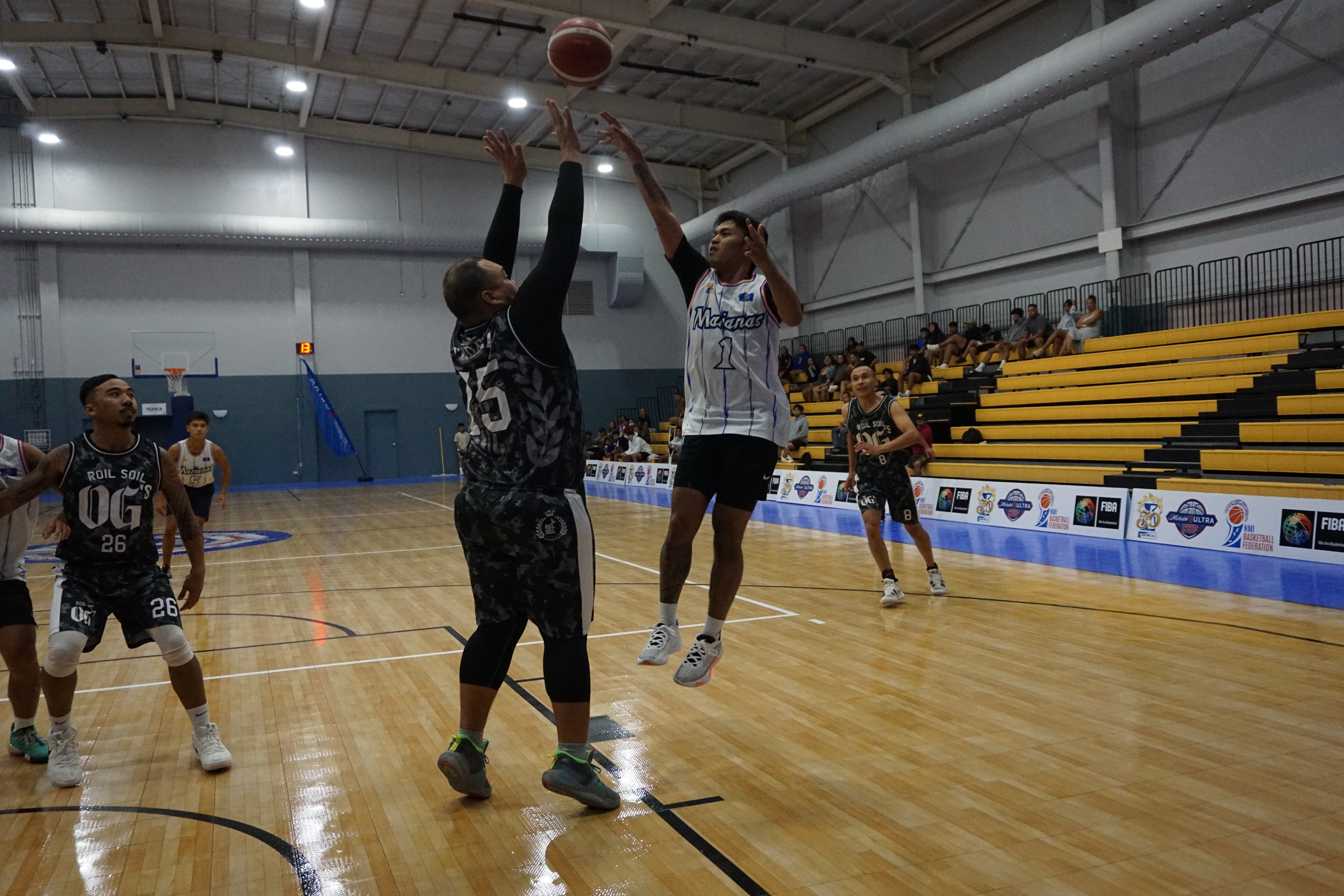 Team Marianas' Keith Santos takes the floater over Roil Soil OG's Ze Tudela during a Michelob Ultra Cup 2023 game Saturday at the Ada gym.