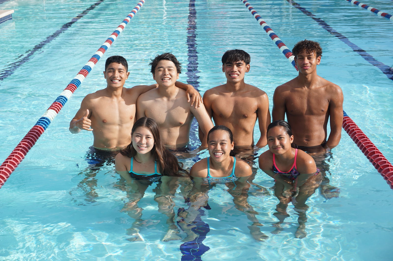The NMI swimmers who will compete in the World Aquatic Championships in Japan and the World Aquatics Junior Swimming Championships in Israel pose for a photo during practice at the Pacific Islands Club-Saipan swimming pool.