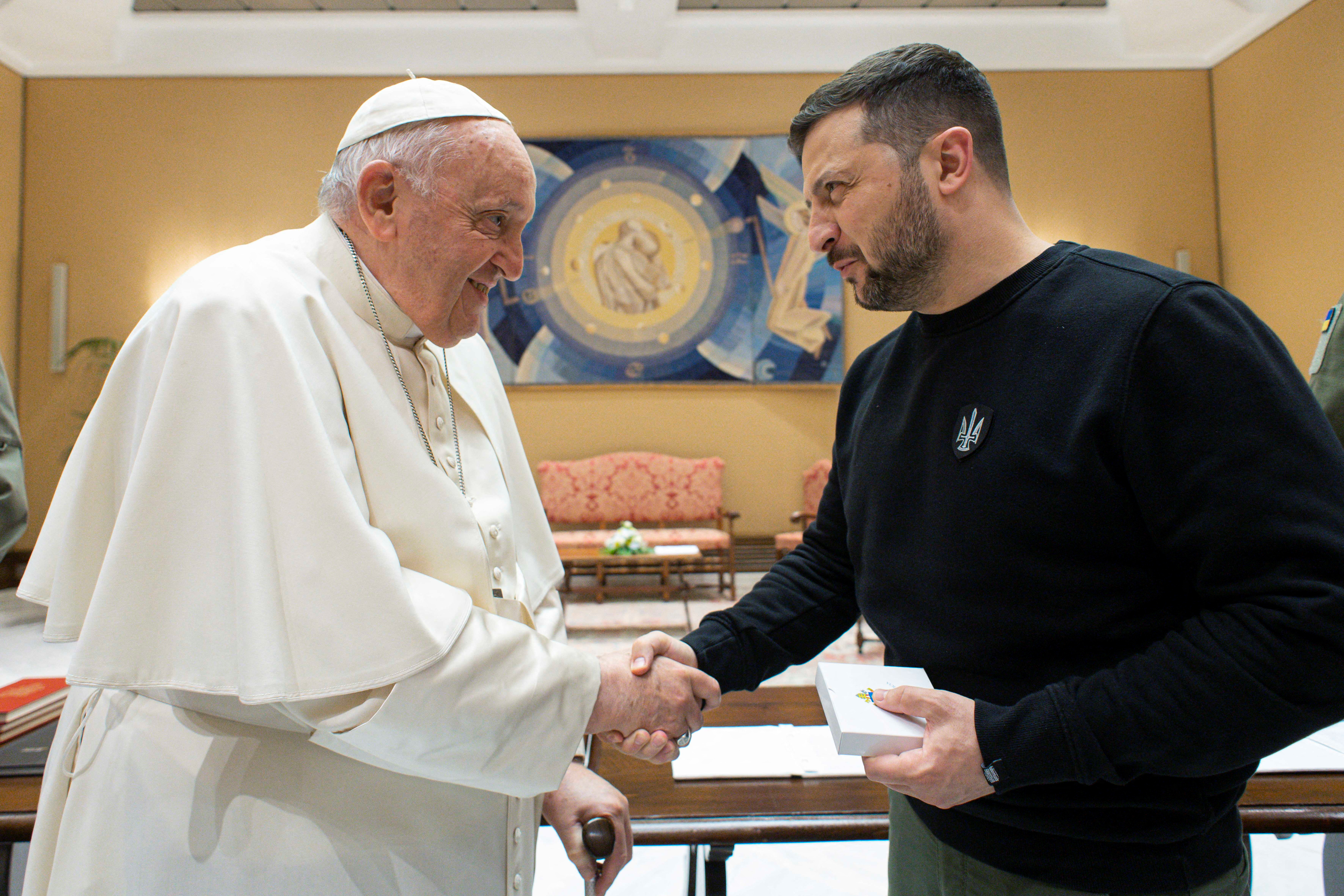 Pope Francis shakes hands with Ukrainian President Volodymyr Zelenskiy, at the Vatican, May 13, 2023. Vatican Media/­Handout via REUTERS