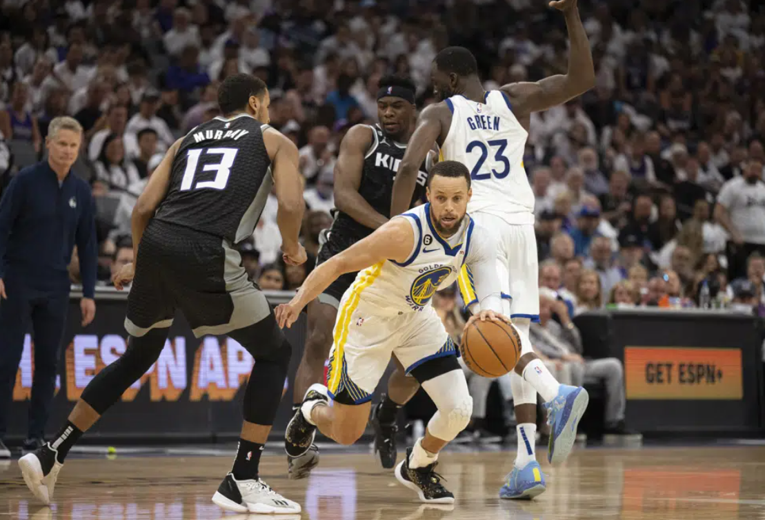 Golden State Warriors guard Stephen Curry (30) fights through a screen set by teammate Draymond Green (23) as Sacramento Kings forward Keegan Murray (13) pursues during the second half of Game 7 of an NBA basketball first-round playoff series Sunday, April 30, 2023, in Sacramento, Calif.