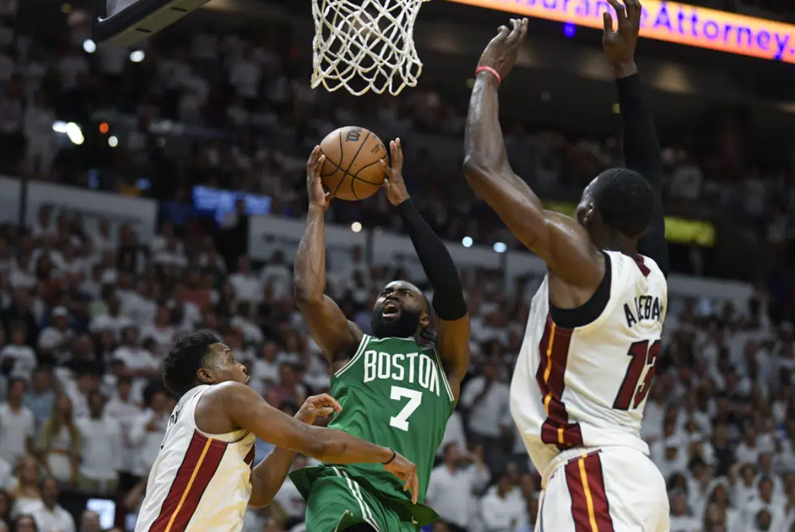 Boston Celtics forward Jaylen Brown (7) goes up for a shot against Miami Heat guard Kyle Lowry, left, and center Bam Adebayo (13) during the second half of Game 6 of the NBA basketball Eastern Conference finals, Saturday, May 27, 2023, in Miami.