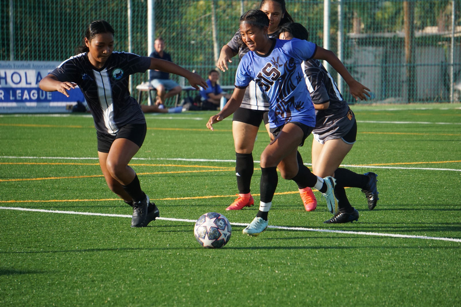 Saipan International School's Kaithlyn Chavez dribbles past three defenders during a girls high school division semifinal match of the NMIFA-PSS Interscholastic Soccer League on Tuesday at the NMI Soccer Training Center in Koblerville.