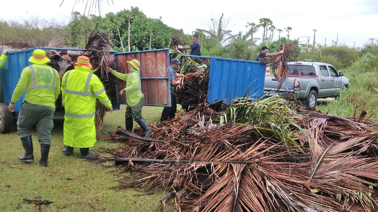 Saipan Mayor Ramon “RB” Camacho's field operations team members remove typhoon debris from a secondary road.