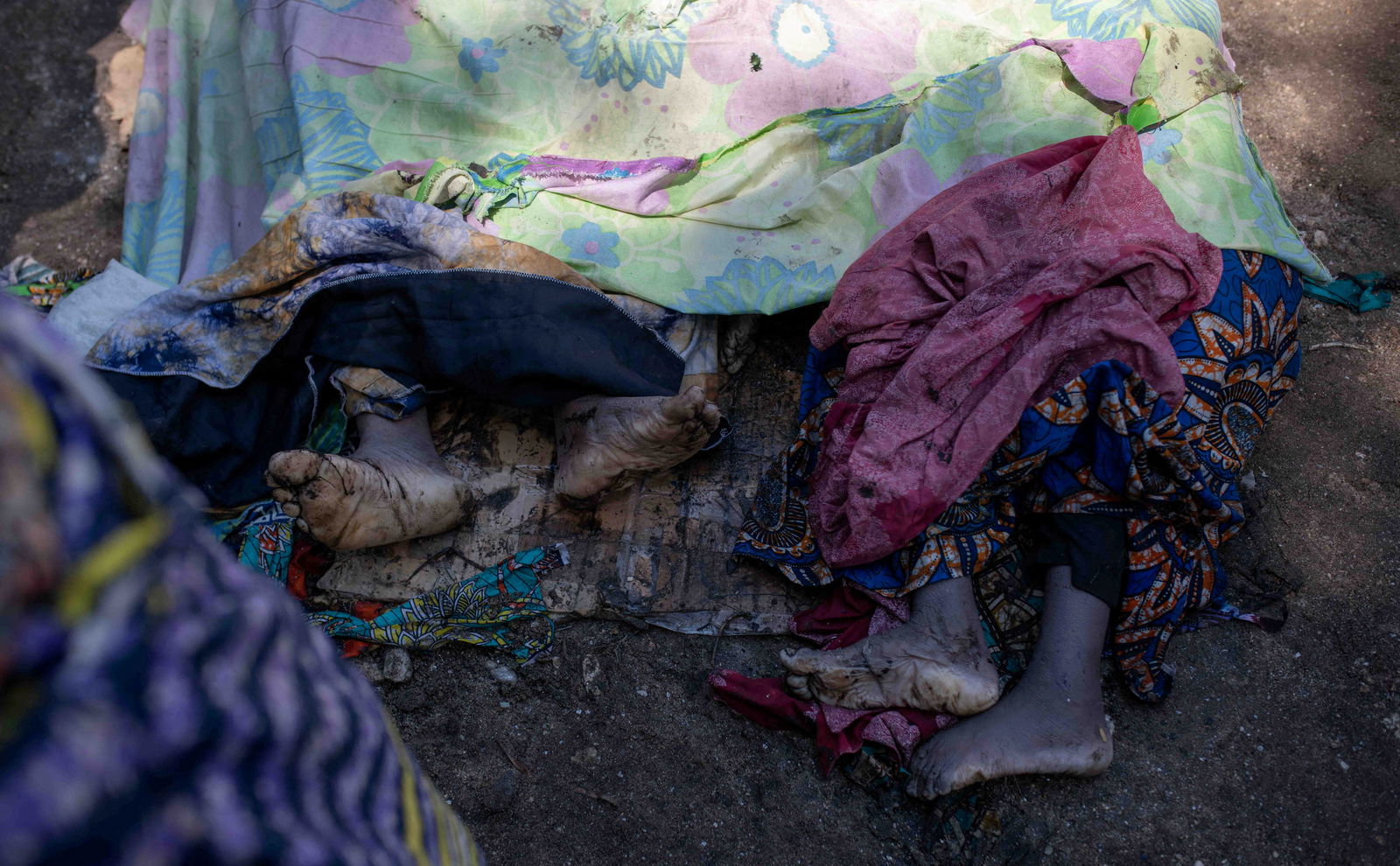 Dead bodies of Congolese civilians killed in floods are covered following rains that destroyed buildings and forced aid workers to gather mud-clad corpses into piles in the village of Nyamukubi, Kalehe territory in South Kivu province of the Democratic Republic of Congo May 6, 2023. REUTERS/Stringer