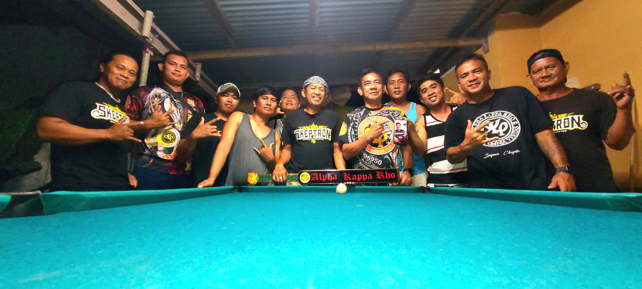 AKRHO members on Saipan flash their fraternity sign as they pose for a photo.