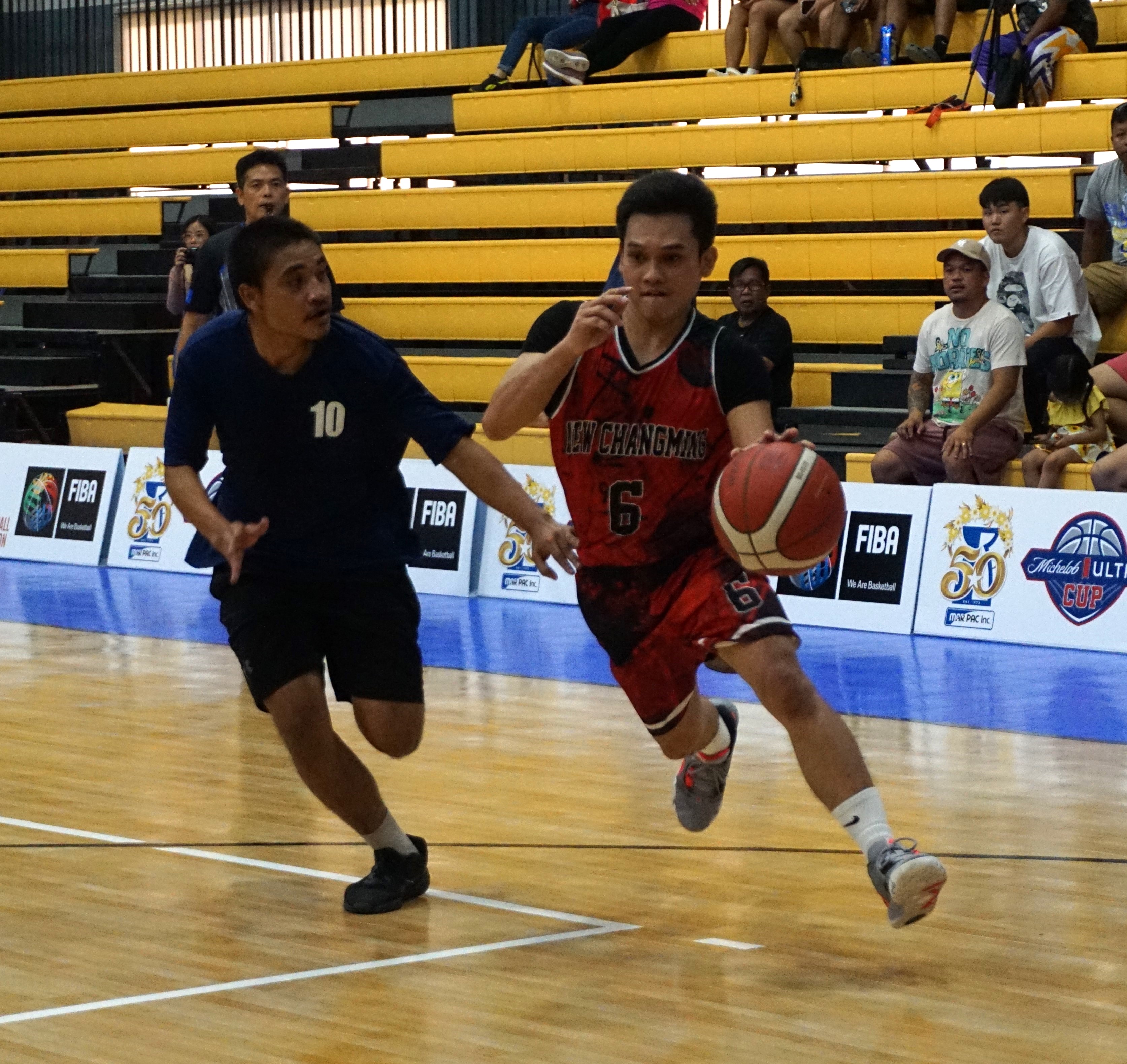 New Chang Ming's Yugi Cruz fends off a defender during a playoff game of the Michelob Ultra Cup 2023 Saturday at the Ada gym.