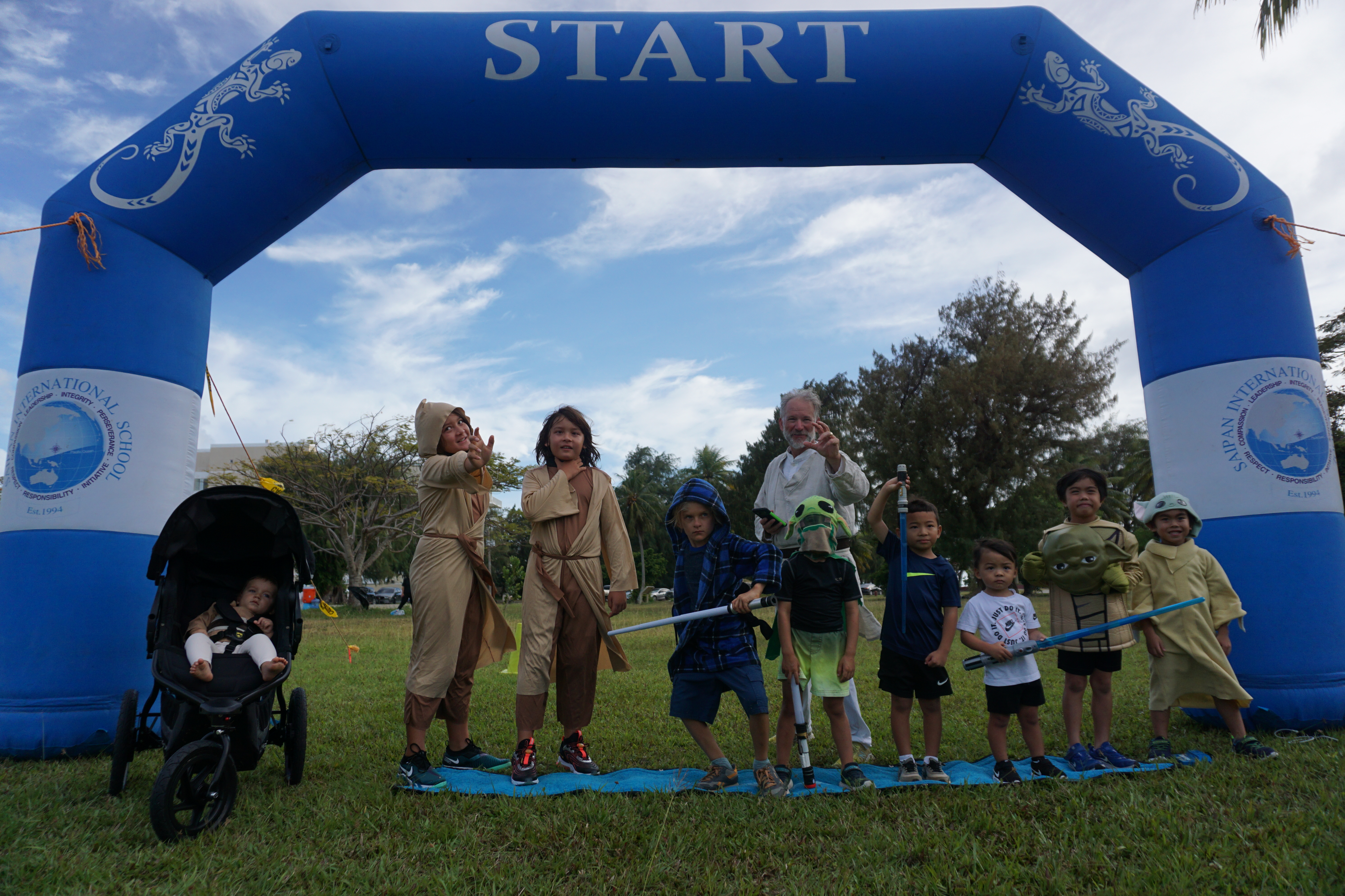 Young participants dressed as Star Wars characters with Jedi master and run organizer Dr. Ron Snyder.