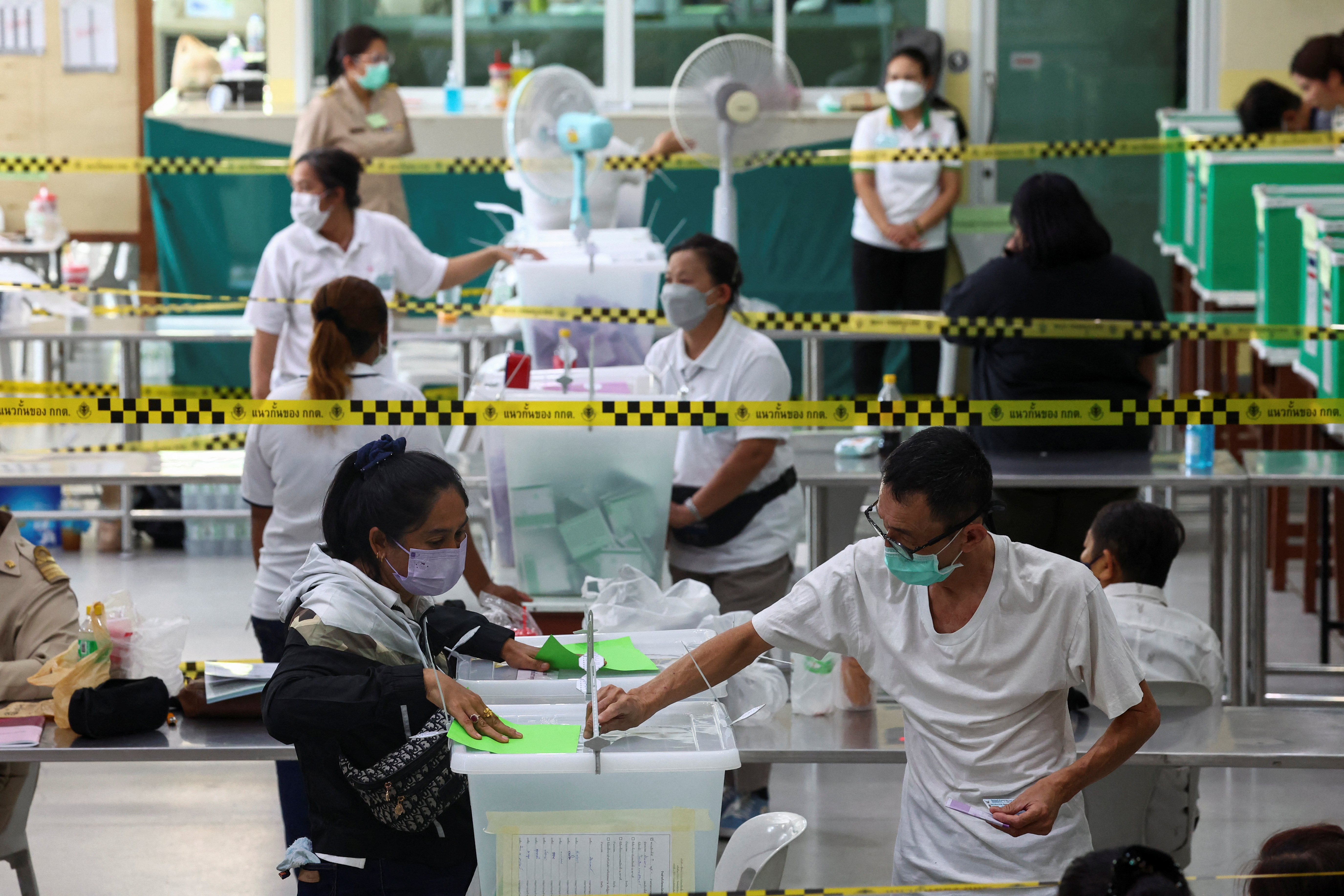 A voter casts a ballot to vote in the general election at a polling station in Bangkok, Thailand, May 14, 2023. REUTERS/Athit Perawongmetha