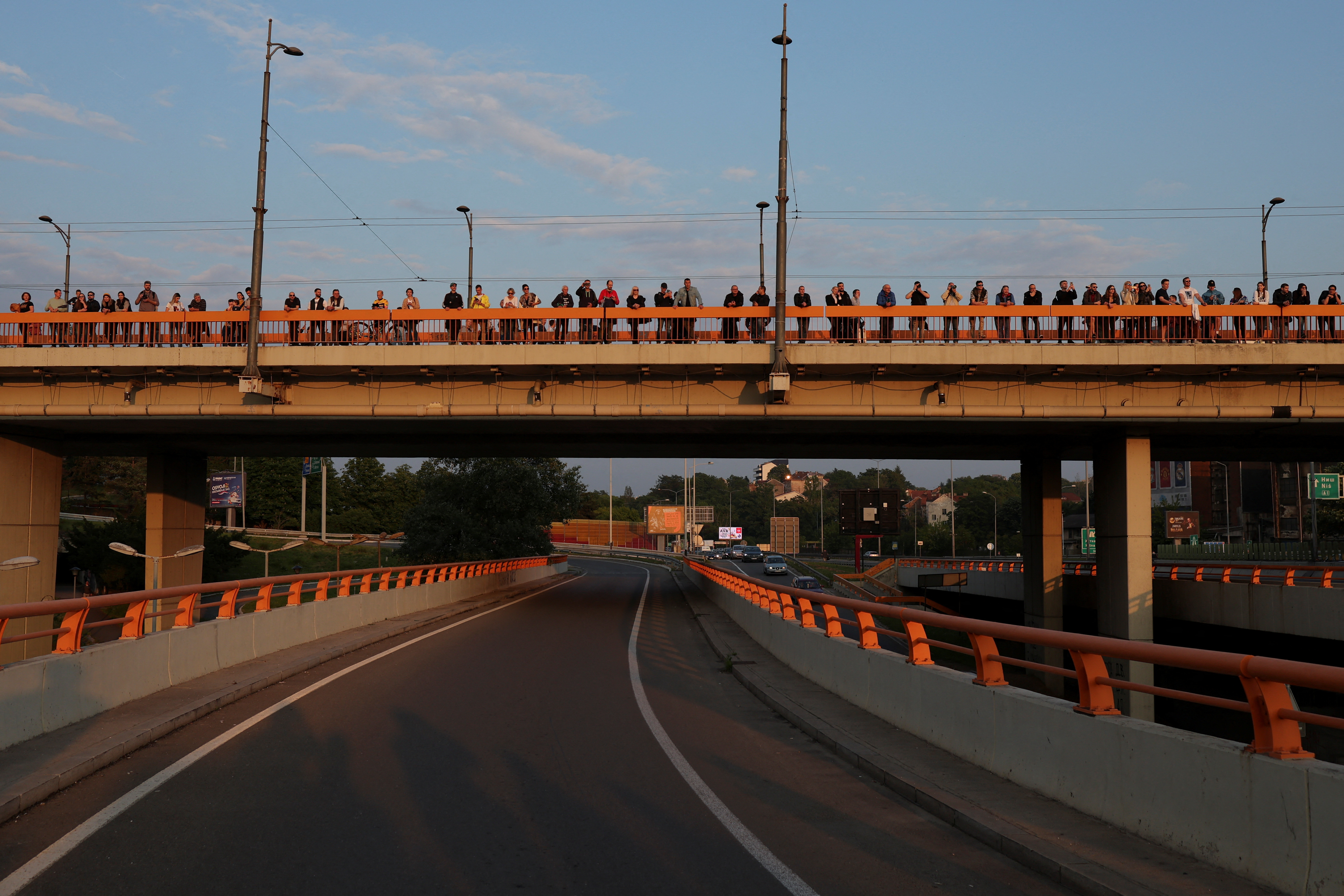 People stand on a bridge as Serbia's main opposition parties protest against violence and in reaction to the two mass shootings in the same week, that have shaken the country, in Belgrade, Serbia, May 19, 2023. REUTERS/Marko Djurica