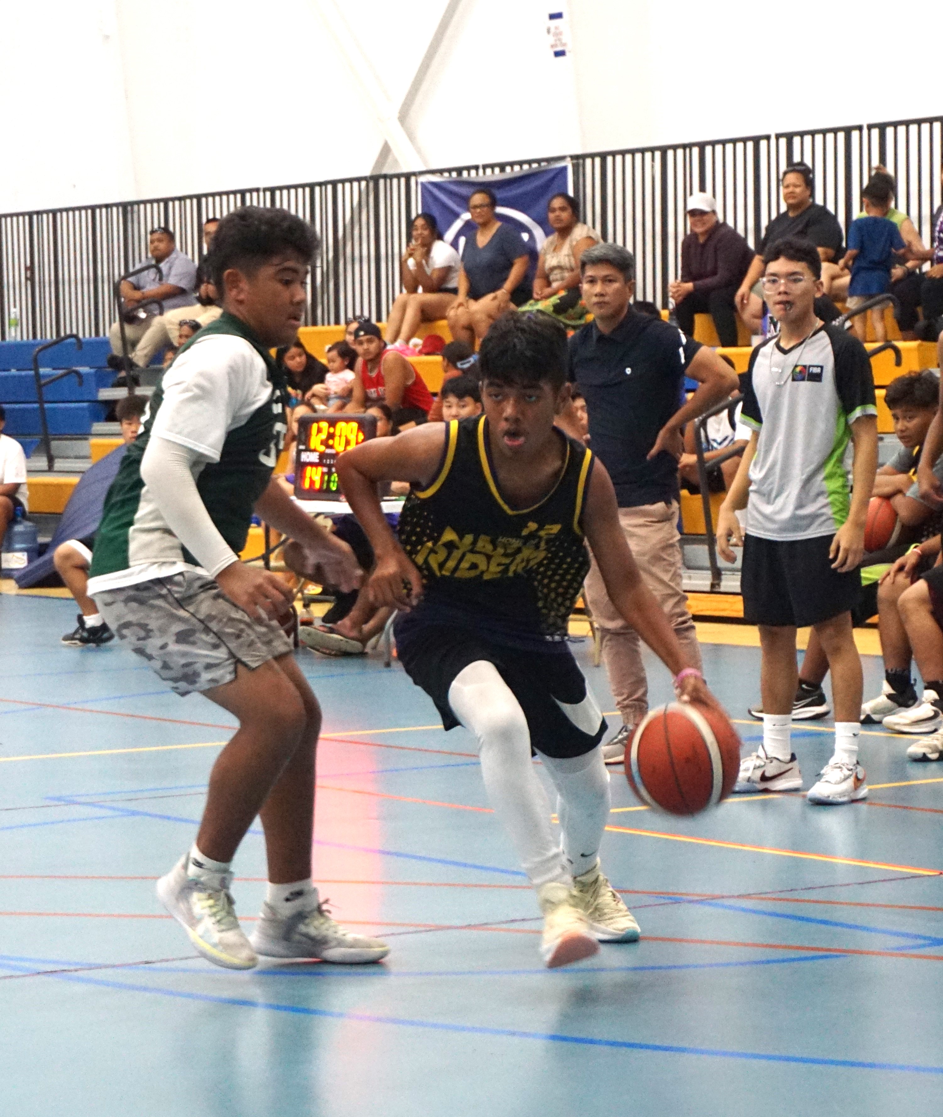 FMS' Dany Defang attempts to dribble past an SIS defender.