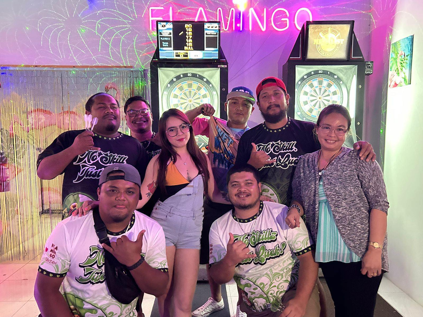 Flamingo NoSkillsJustLuck players pose after their victory against the Bourbon Drunken Dartz in the Thursday B Flame Tree Division of the SEDA Bud Light Dart League at the Flamingo Tavern.