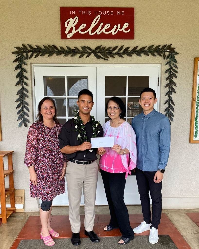 Joe E. Ayuyu Jr., McDonald’s of Guam and Saipan owner/operator, 2nd left, presents a check for $5,000 to Jerri Chong, Ronald McDonald House Charities Hawaii president.