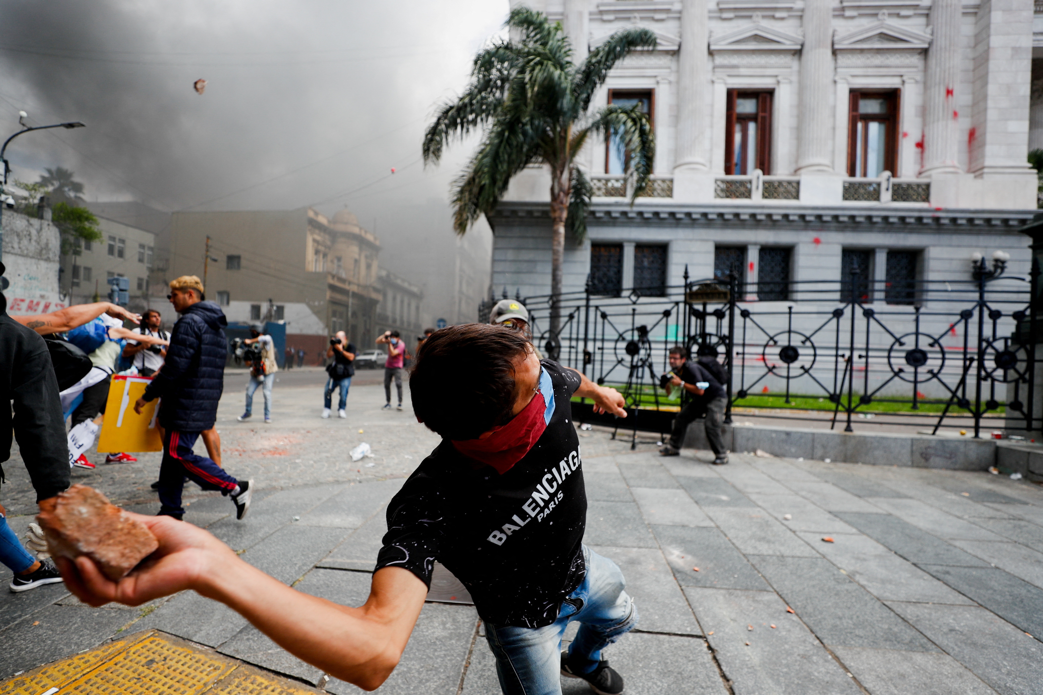 FILE PHOTO: A demonstrator throws a stone during a protest outside the National Congress, as members of the parliament debate the government's agreement with the International Monetary Fund (IMF), in Buenos Aires, Argentina March 10, 2022. REUTERS/Agustin Marcarian