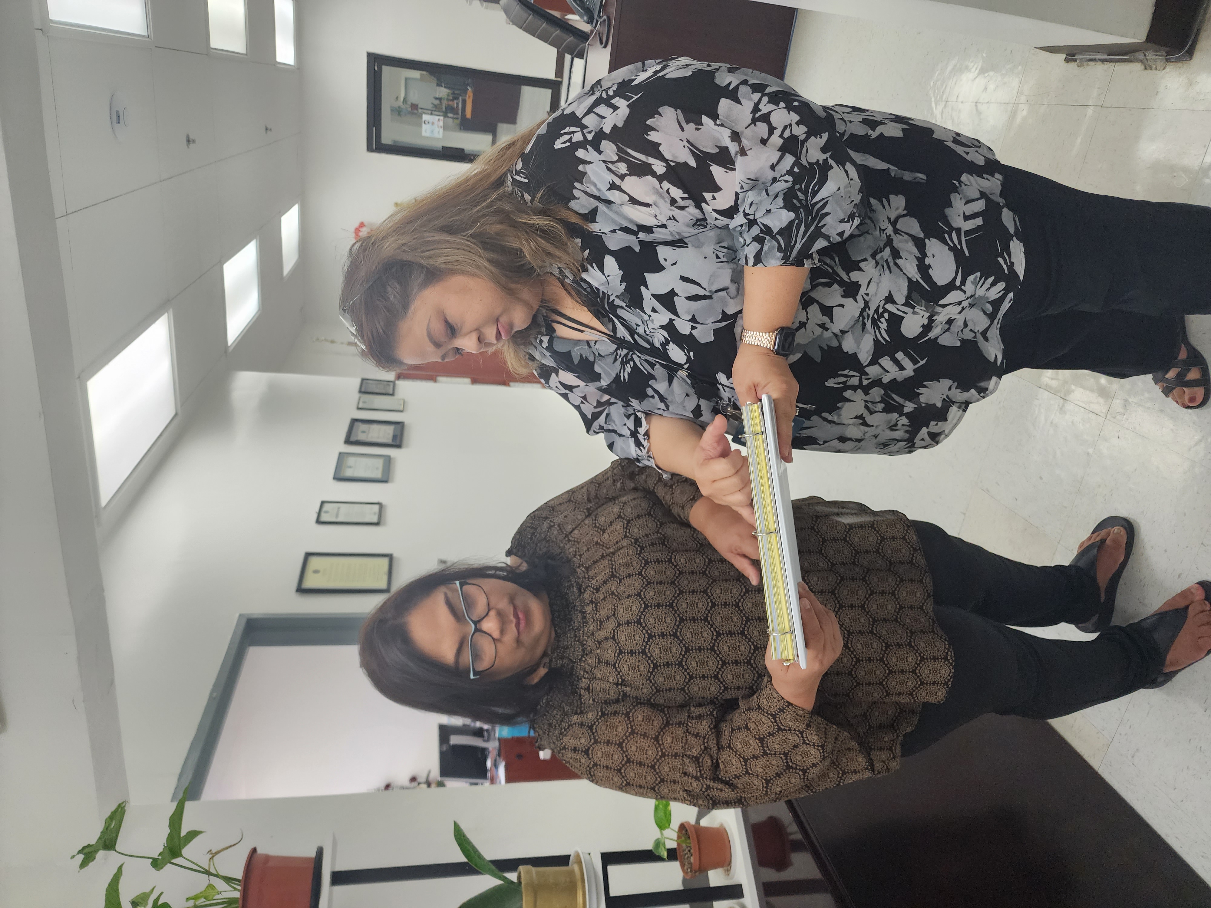 Commonwealth Utilities Corp. Board Chair Janice Tenorio and CUC acting Executive Director Betty Terlaje look at the list of delinquent government agencies on Tuesday.