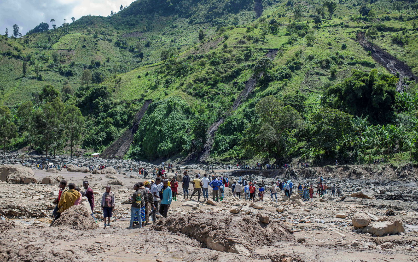 Congolese civilians gather after the death of their family members following rains that destroyed buildings and forced aid workers to gather mud-clad corpses into piles, in the village of Nyamukubi, Kalehe territory in South Kivu province of the Democratic Republic of Congo May 6, 2023. REUTERS/Stringer