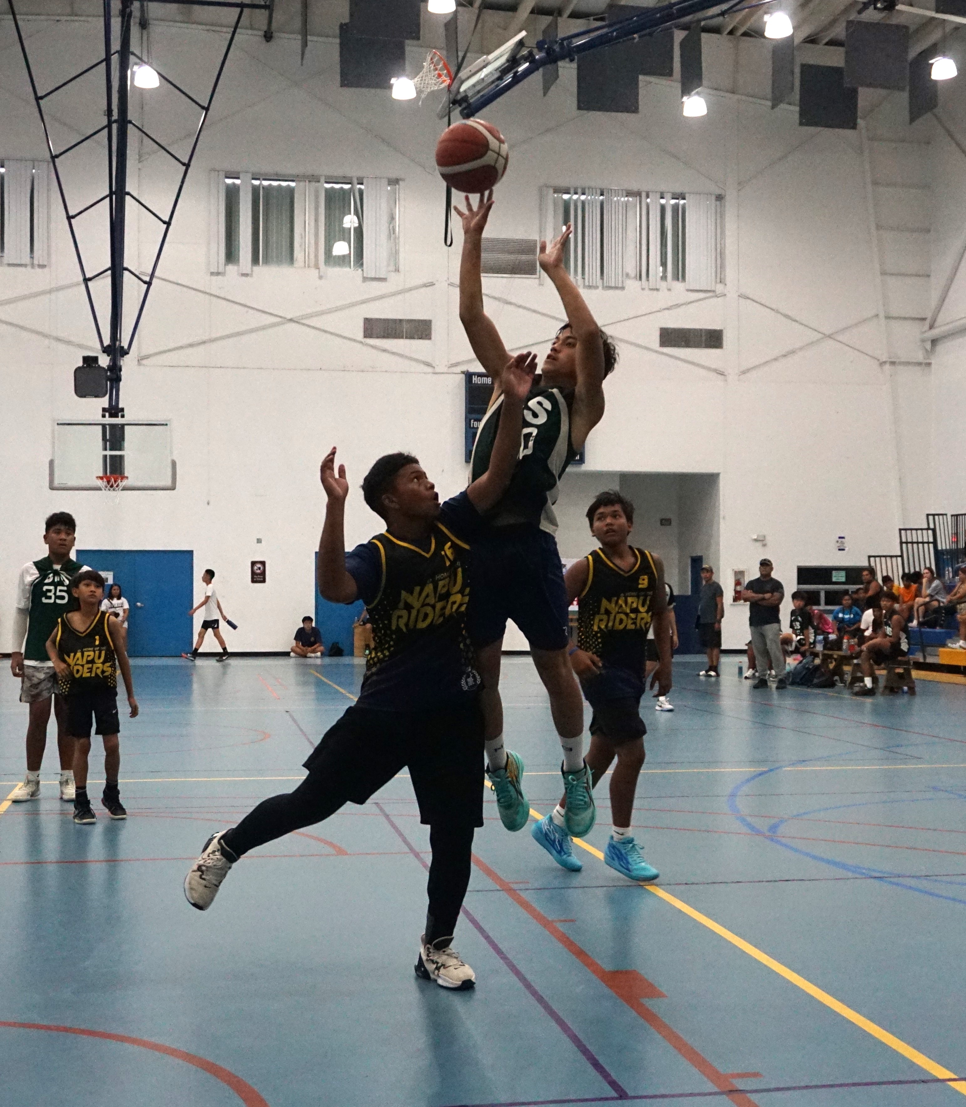 SIS' Audiescott Iakopo takes the shot over a defender.