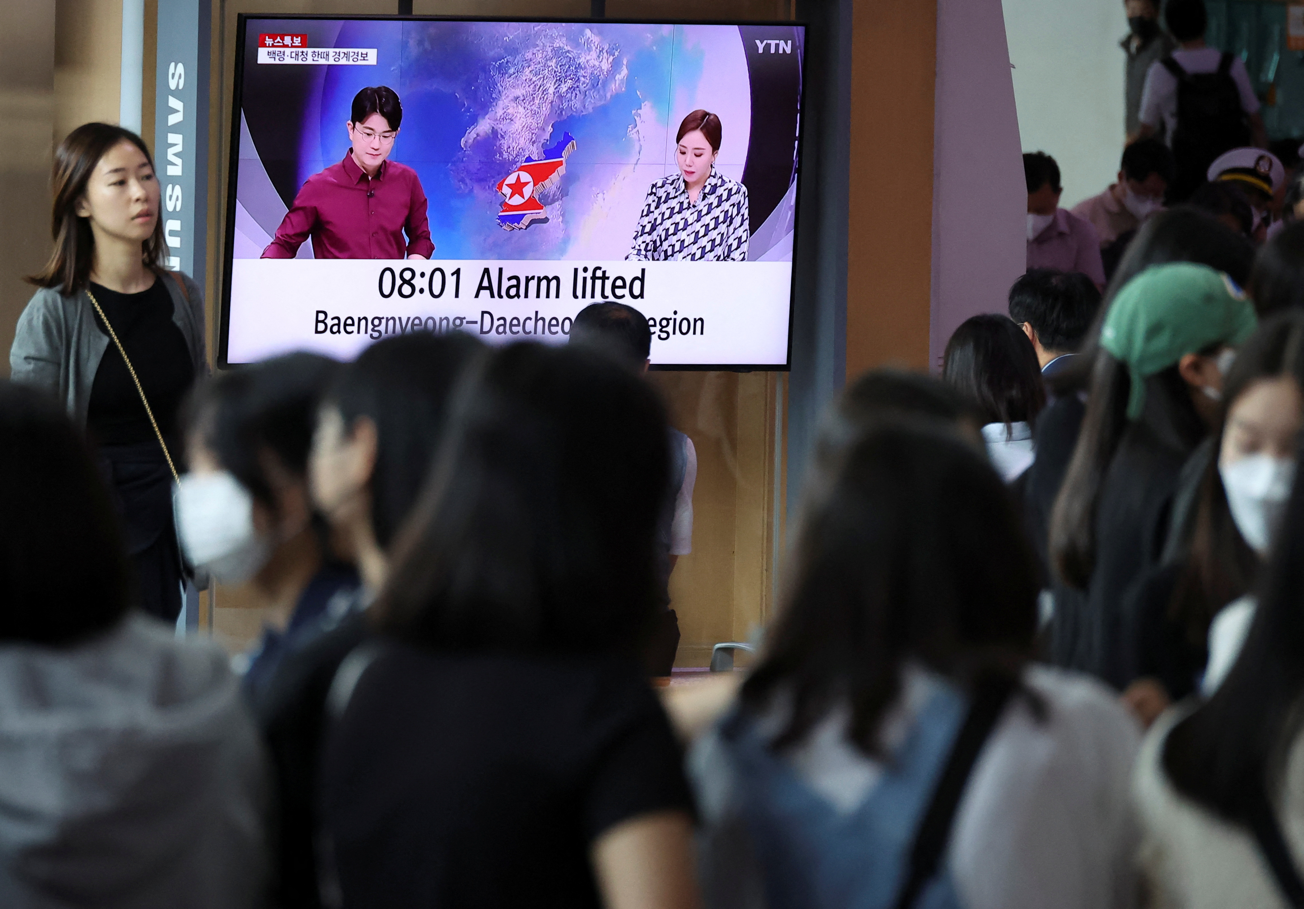 People watch a TV broadcasting a news report on North Korea firing what it called a space satellite toward the south, in Seoul, South Korea, May 31, 2023. REUTERS/Kim Hong-Ji