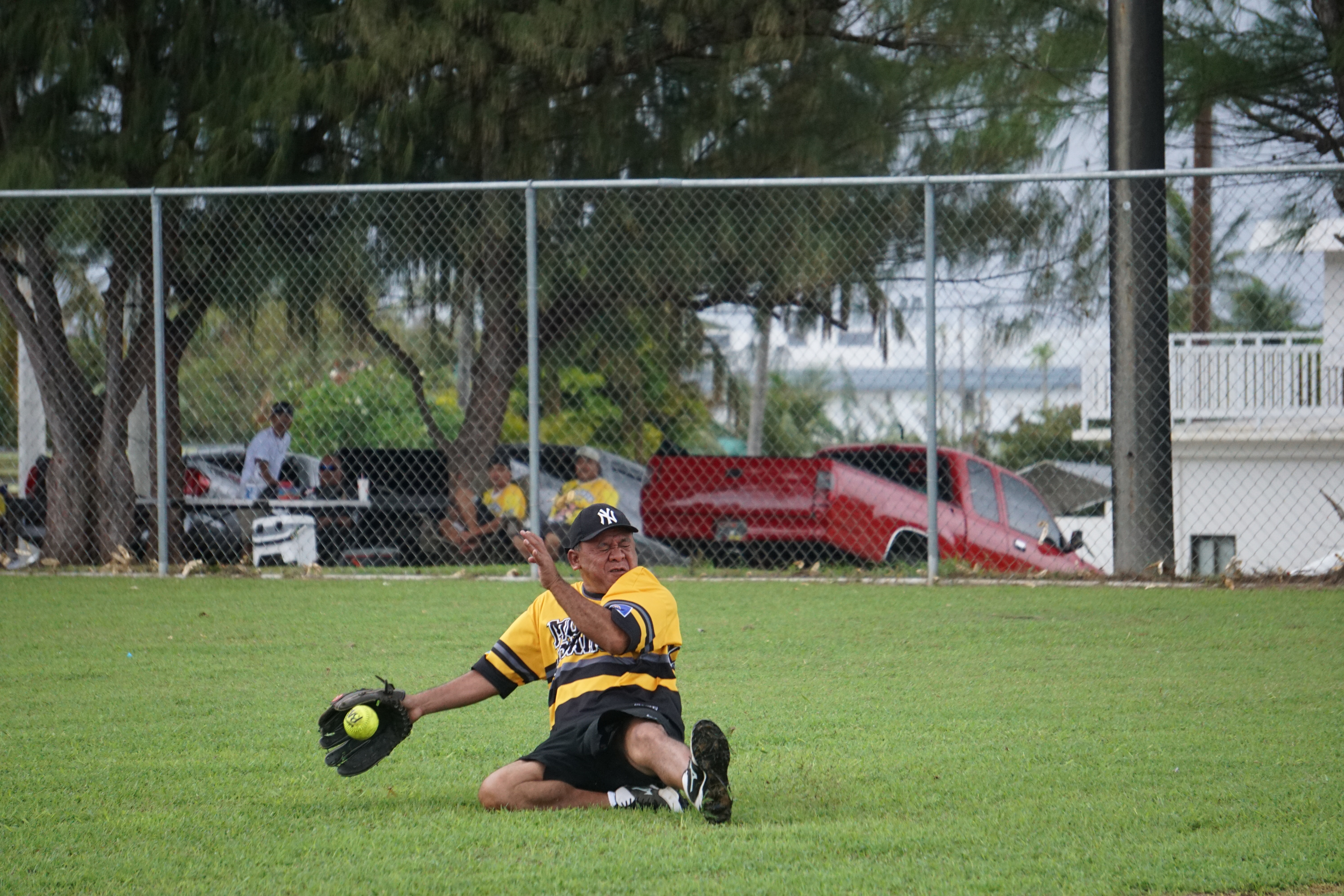 Momma Charu rightfielder Berand Kileleman slides to catch the line drive for the out during a Budweiser Belau Amateur Softball League game Sunday at the Dandan baseball field.