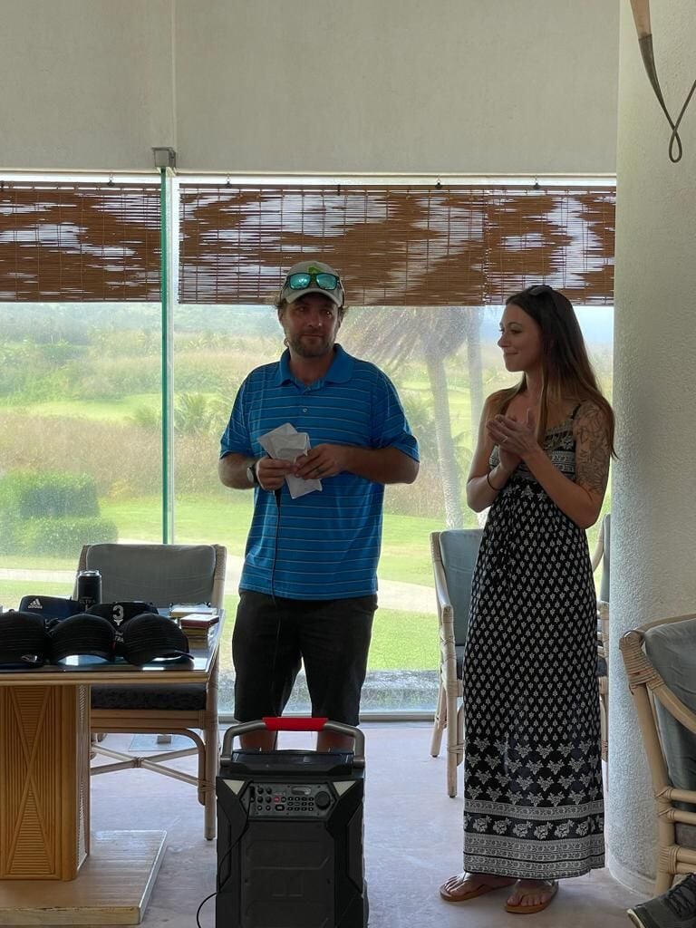 Dan Wollak donates the proceeds of the 14th Wollak Golf Classic to Lauren Cabrera, president of the Saipan Humane Society, on Sunday at the Kingfisher Golf Links.