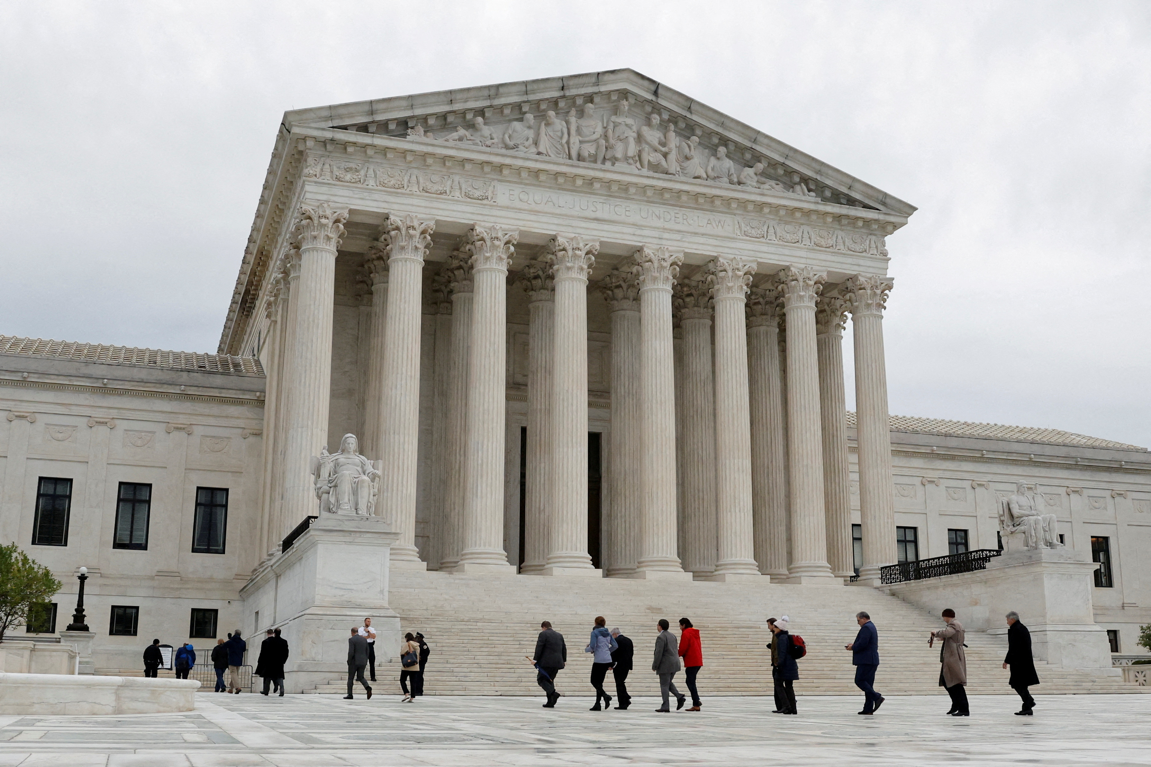 FILE PHOTO: People walk across the plaza of the U.S. Supreme Court building on the first day of the court's new term in Washington, U.S. October 3, 2022. REUTERS/Jonathan Ernst/File Photo