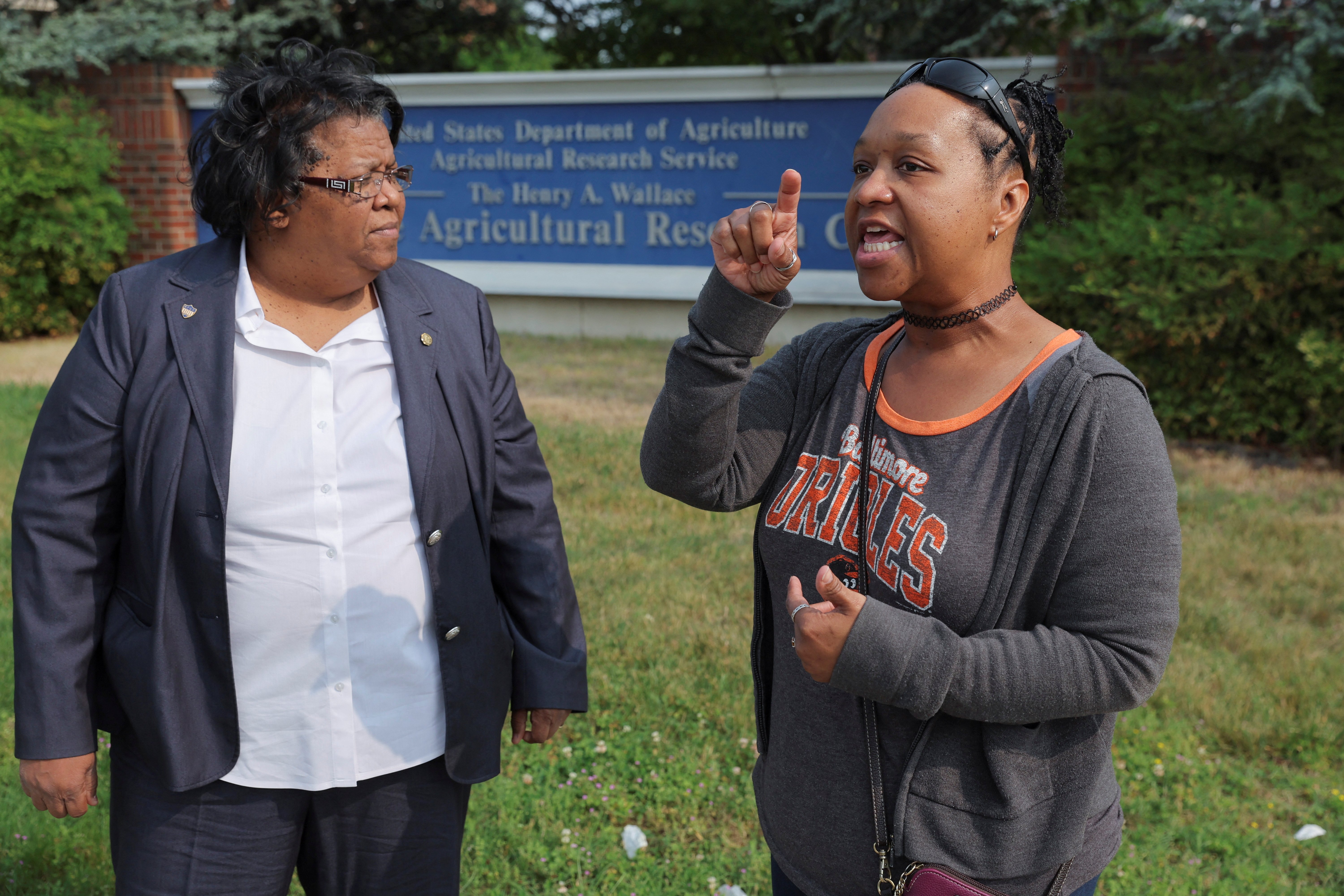 Claudette Joyner, president of the American Federation of Government Employees (AFGE) Local 3147 and a realty specialist at the U.S. Department of Agriculture’s (USDA) Beltsville Agricultural Research Center (BARC) and Ashaki "Teddi" Mitchell, vice-president of AFGE Local 3147 and a biological science laboratory technician at the same facility, talk to a reporter about an employee whistleblower complaint alleging unsafe work conditions for employees at the center as they stand in front of the farm research facility in Beltsville, Maryland, U.S. May 17, 2023. REUTERS/Jim Bourg