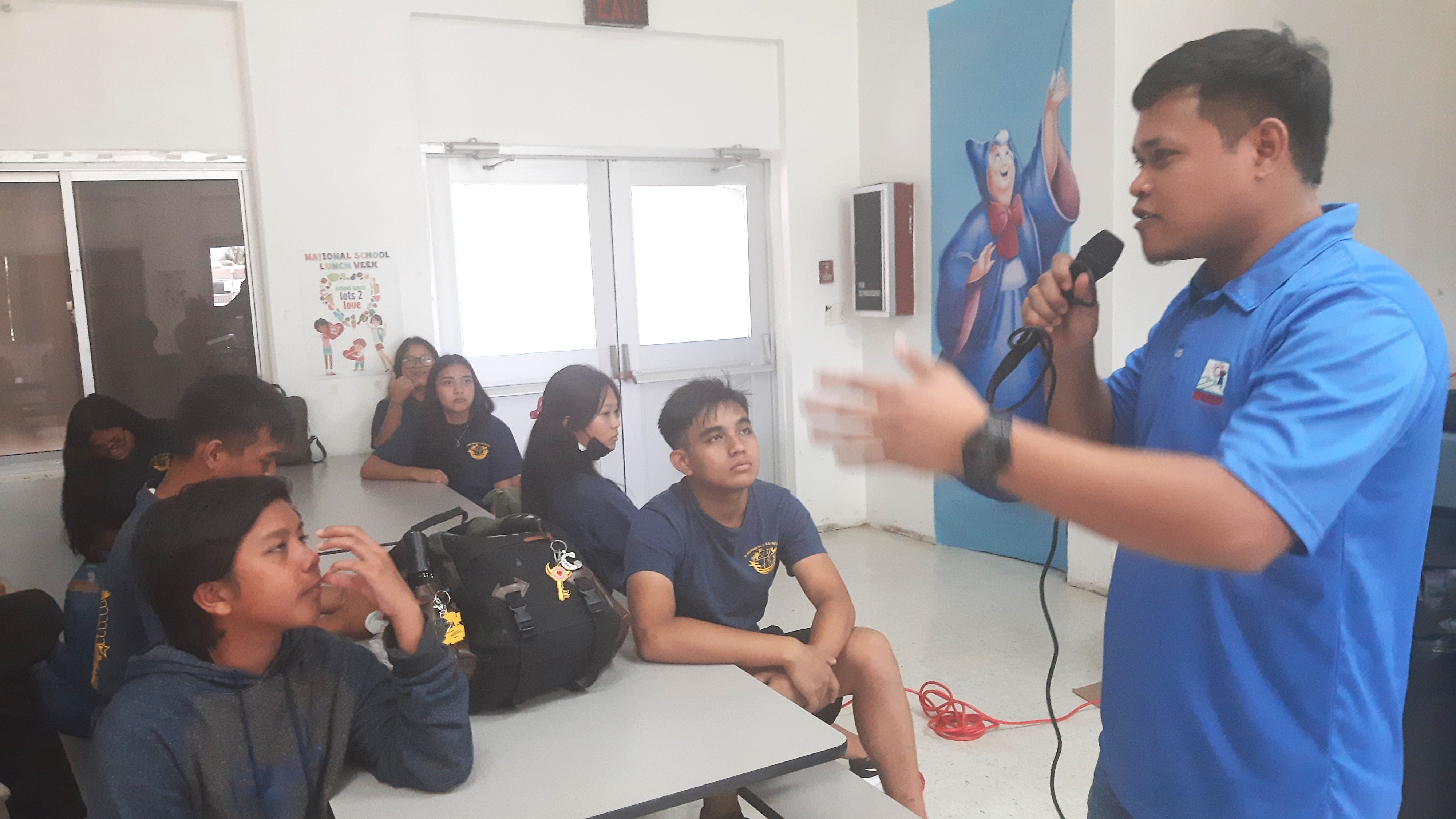 Marianas Visitors Authority Community Projects Specialist Jack Aranda addresses students at Dr. Rita S. Inos Jr./Sr. High School on April 19, 2023, and shares about the functions of the tourism office.
