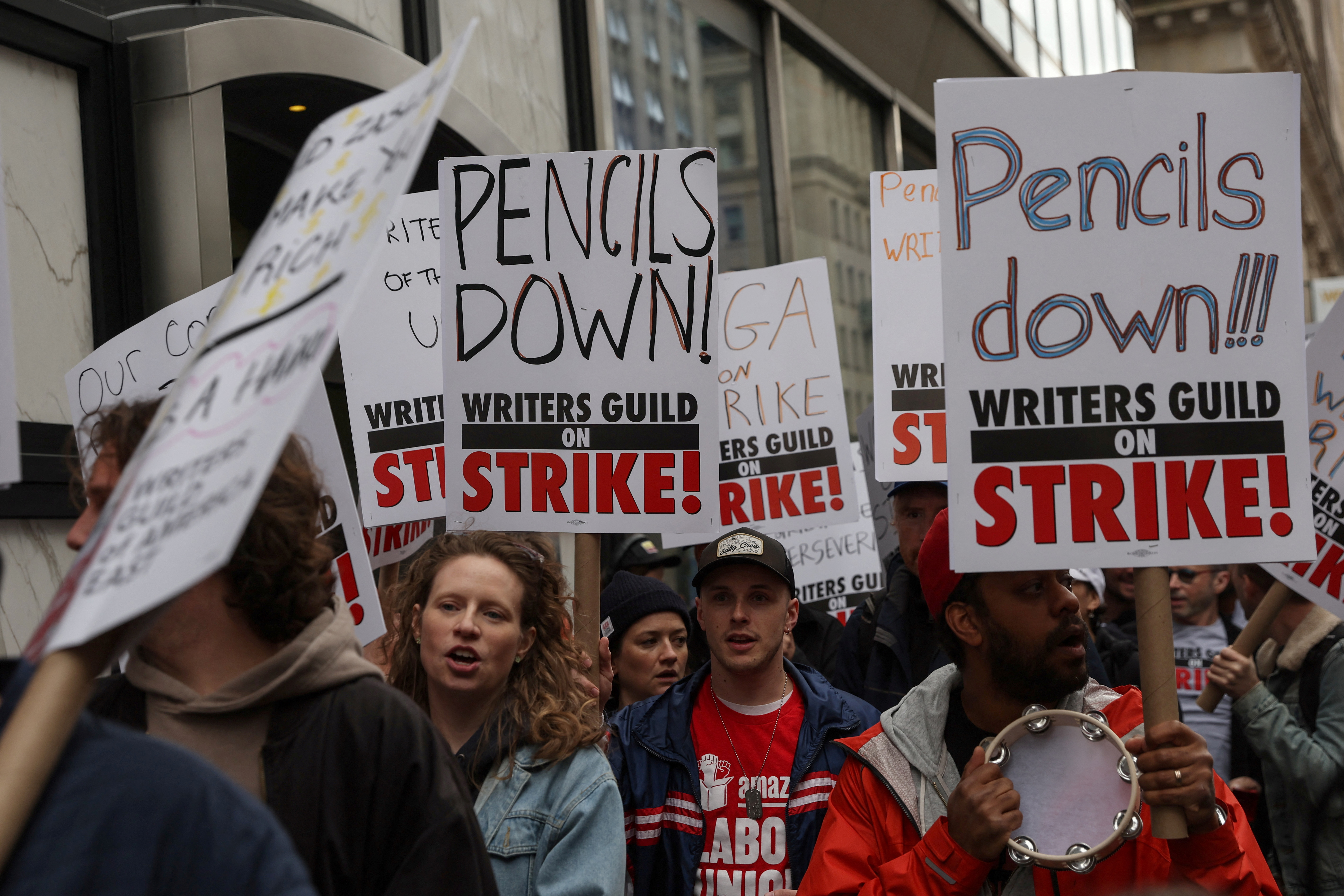 Members of the Writers Guild of America (WGA) East picket outside Peacock Newfront streaming service offices, in New York City, U.S., May 2, 2023. REUTERS/Shannon Stapleton