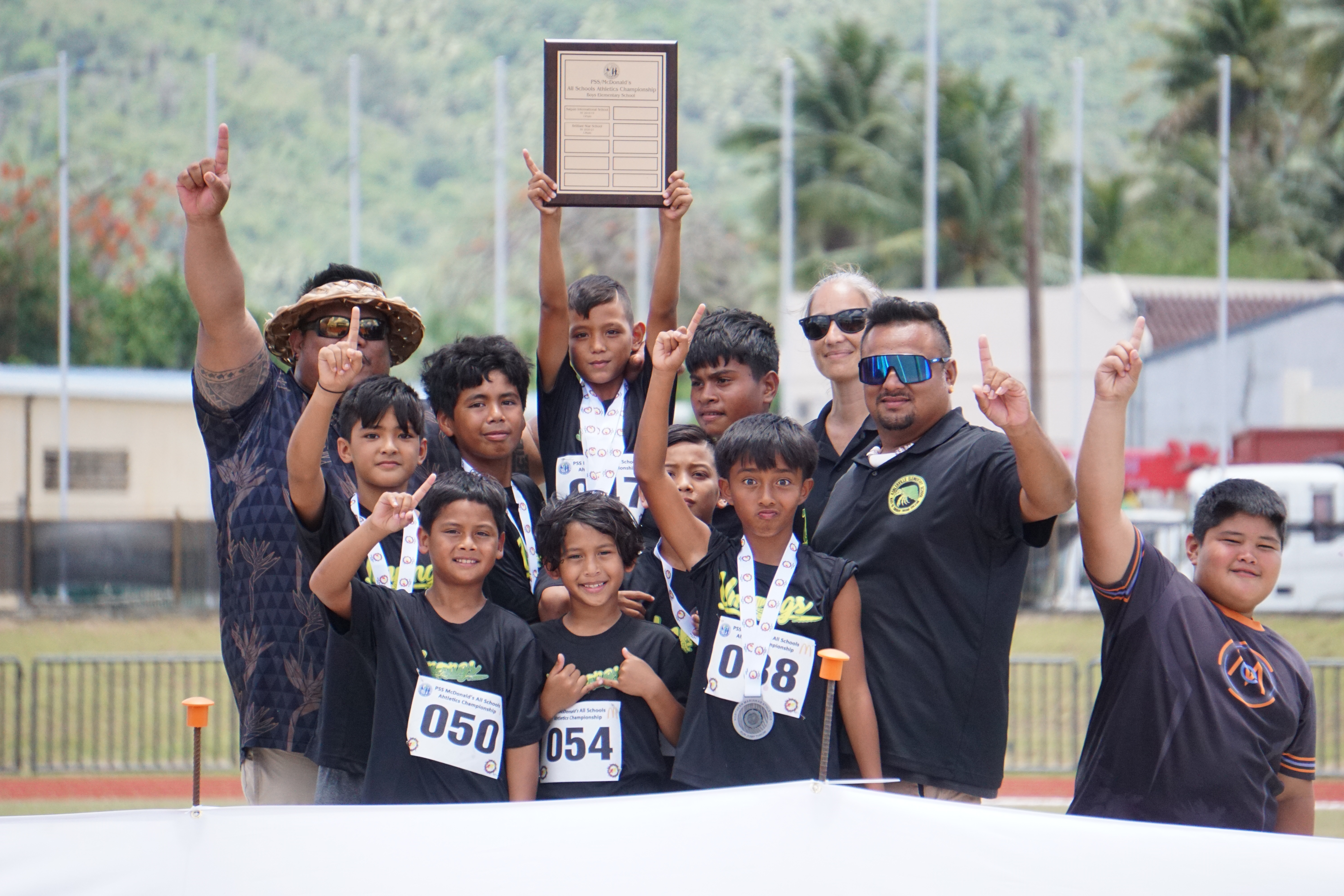 The Koblerville Elementary School team members pose with the first place trophy after winning the boys elementary school division championship of the PSS-McDonalds All School Athletics Championships on Saturday at the Oleai Sports Complex.