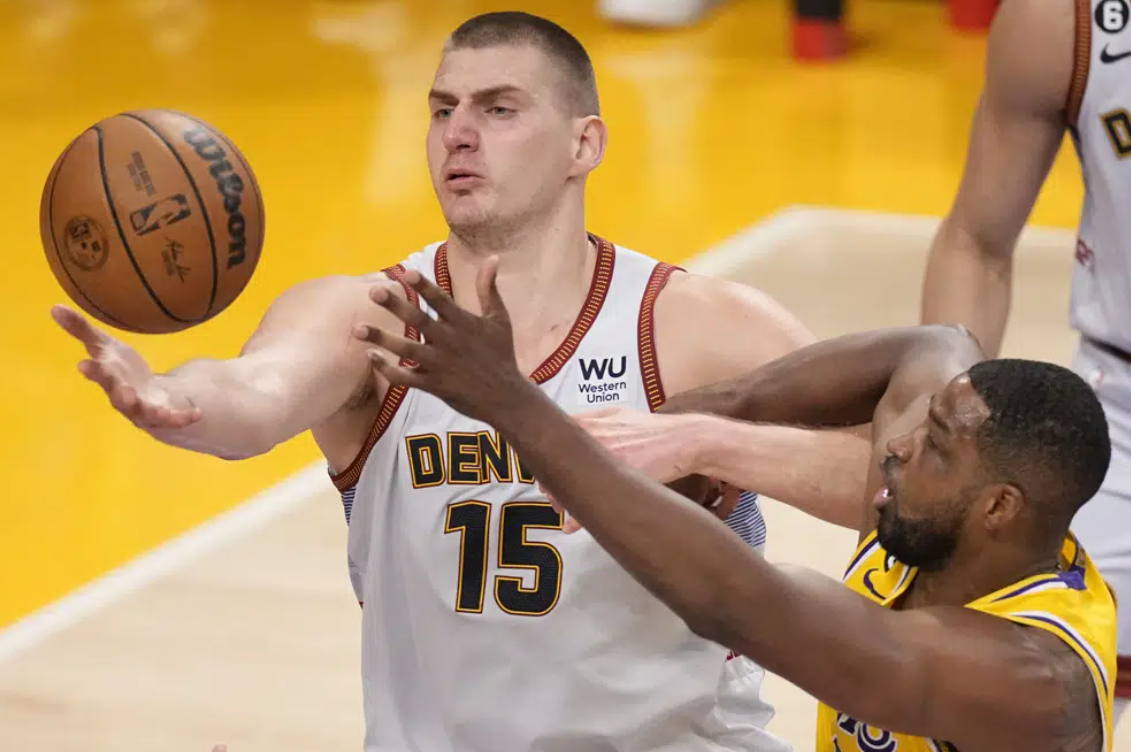 Denver Nuggets center Nikola Jokic (15) grabs a rebound next to Los Angeles Lakers center Tristan Thompson in the first half of Game 4 of the NBA basketball Western Conference Final series Monday, May 22, 2023, in Los Angeles.