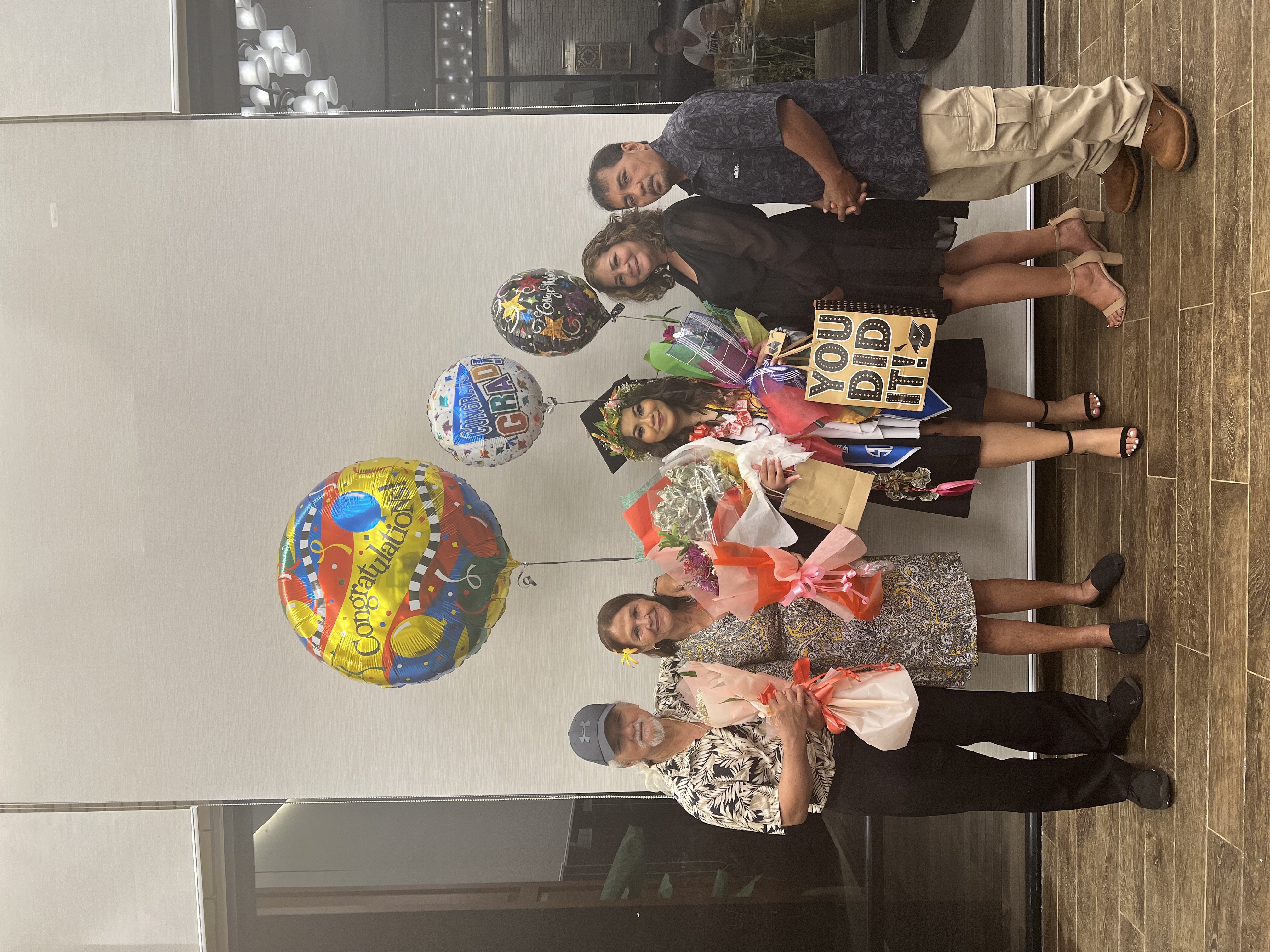Tianna B. Villagomez and her family members pose for a photo after the Northern Marianas College graduation ceremony on Friday.