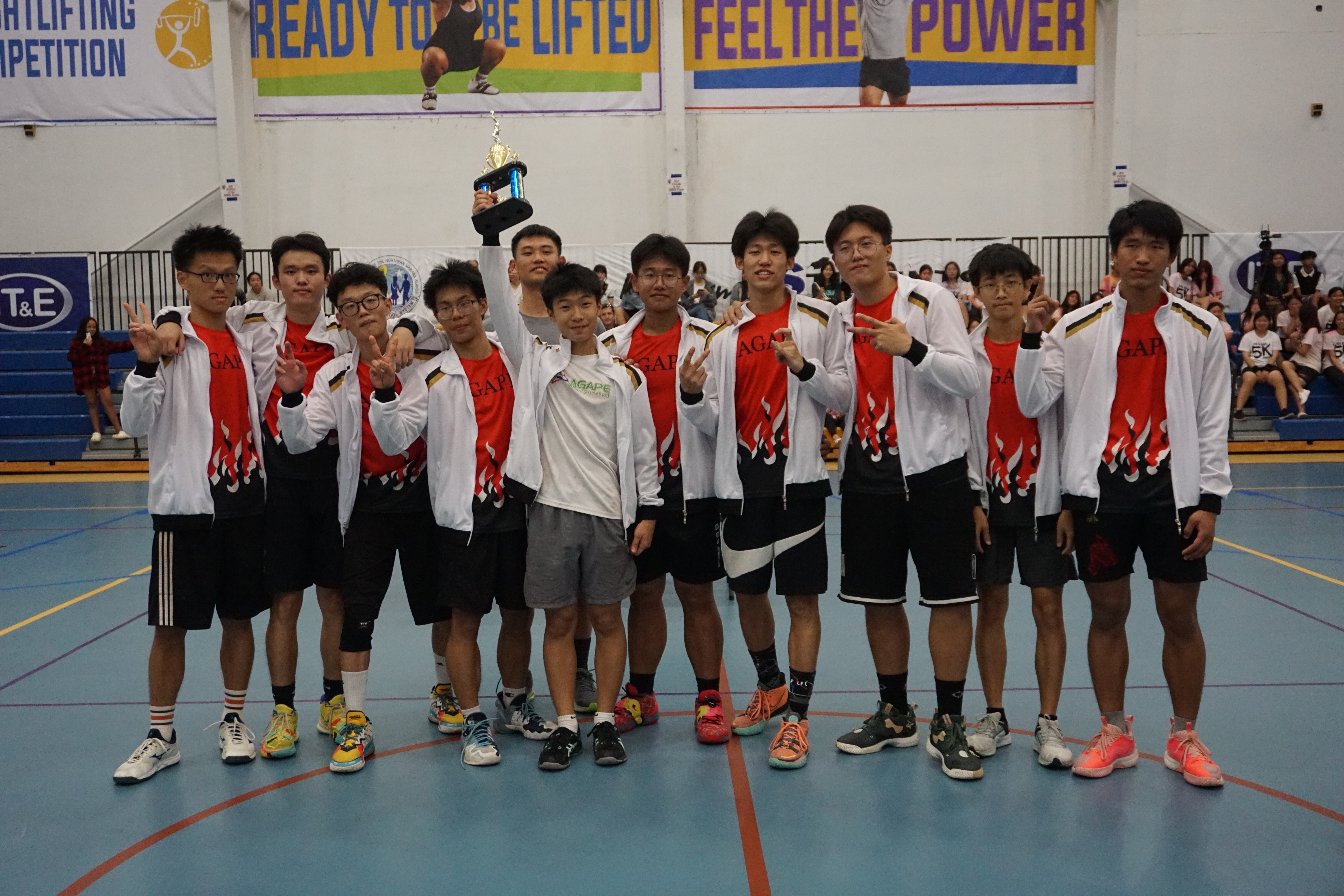 Agape Christian School players pose with the second-place trophy in the boys high school division of the PSS-NMIVA Interscholastic Volleyball League at the MHS gym on Saturday.