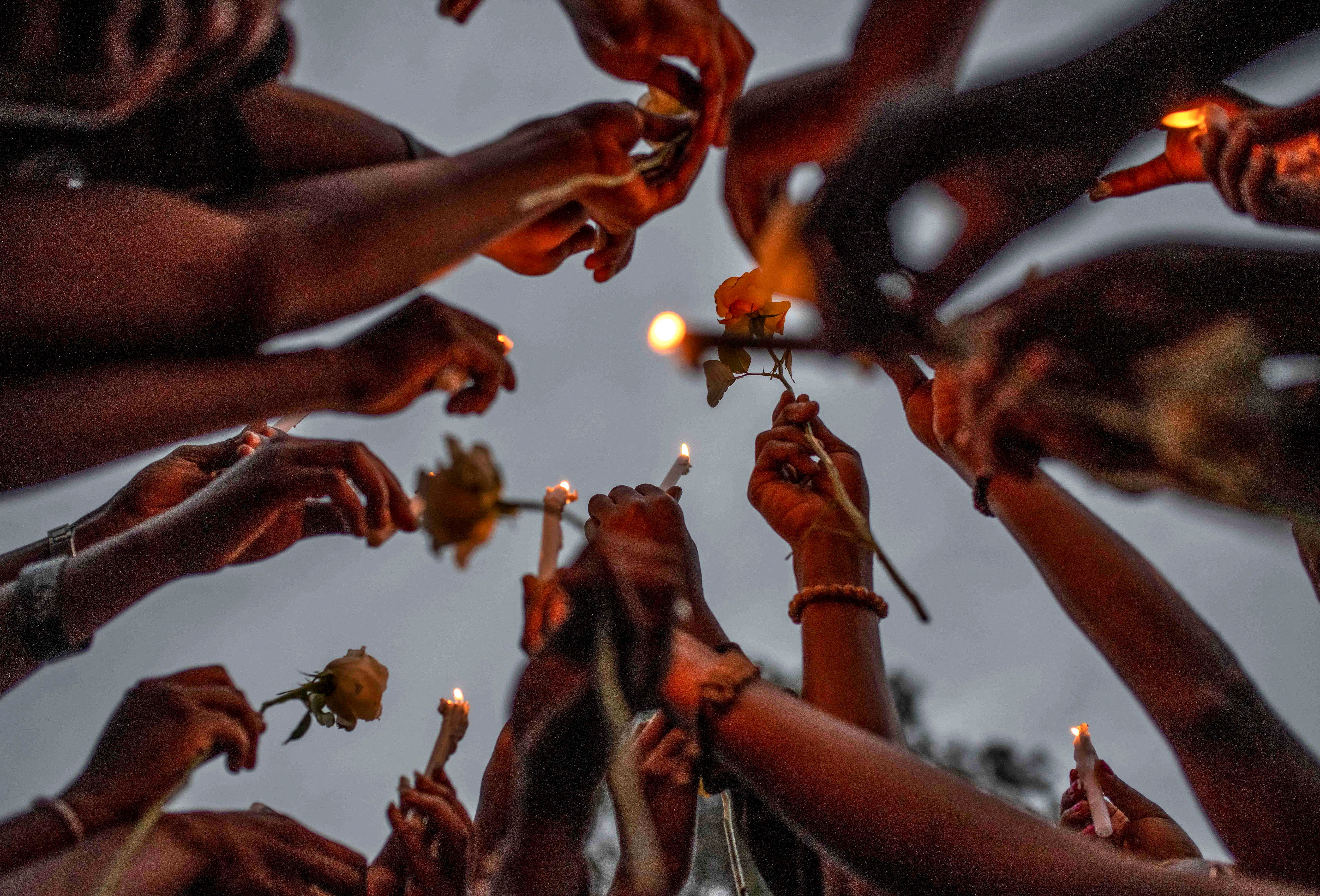 Congolese civilians hold candles to pay tribute to the victims killed by rains that destroyed the remote, mountainous area and ripped through the riverside villages of Nyamukubi, Kalehe territory in South Kivu province, during a vigil in Goma, Democratic Republic of Congo May 9, 2023. REUTERS/Stringer
