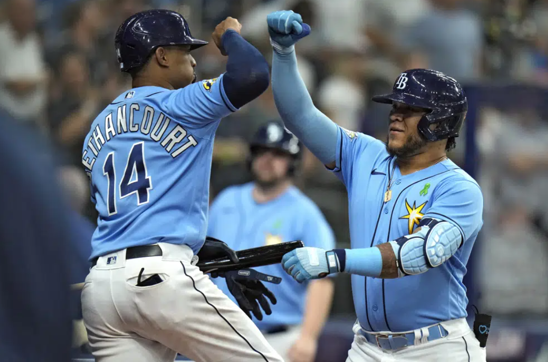 Tampa Bay Rays' Harold Ramirez celebrates his solo home run off Pittsburgh Pirates starting pitcher Roansy Contreras with Christian Bethancourt (14) during the sixth inning of a baseball game Tuesday, May 2, 2023, in St. Petersburg, Fla.