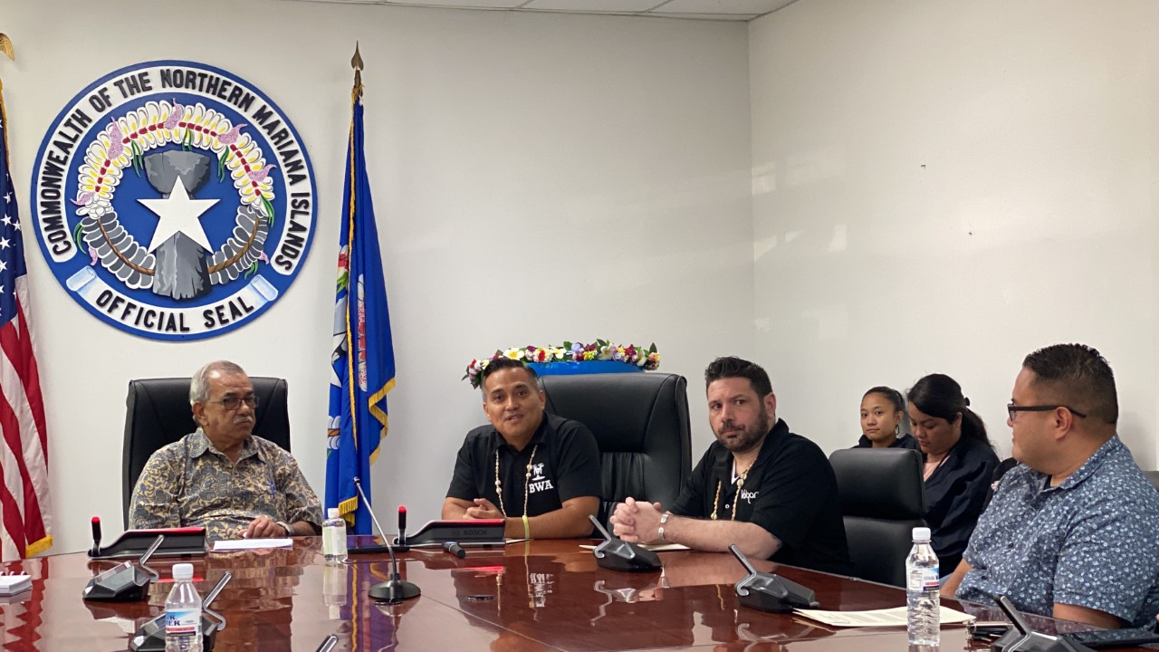 Charlie Hermosa, 2nd left, and Ryan Walsh, 2nd right, with the governor’s special assistant for administration, Oscar M. Babauta, left, and Rep. Manny Gregory T. Castro.