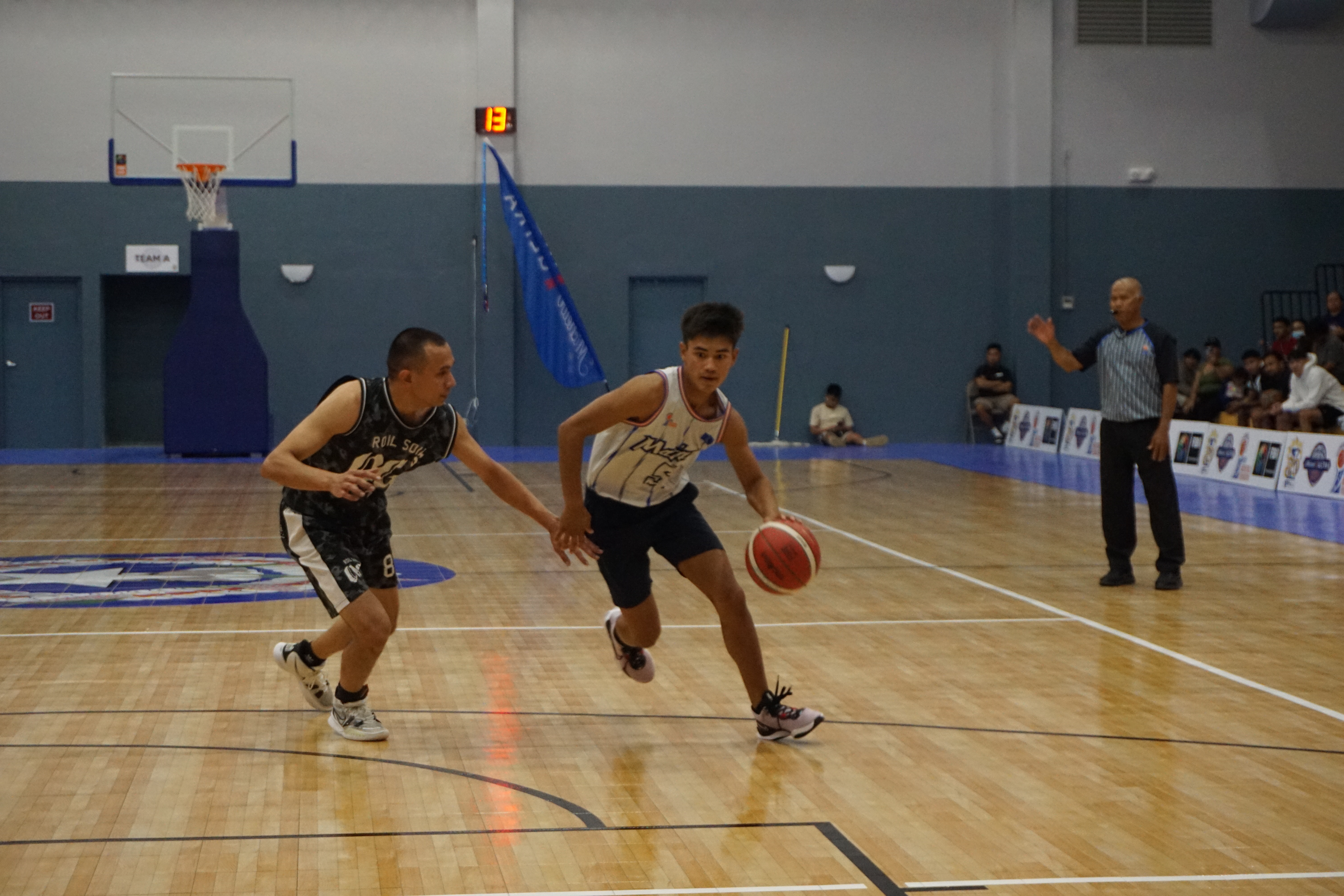 Team Marianas' Matthew Richardson attempts to dribble past Roil Soil OG's Sid Quan during a Michelob Ultra Cup 2023 game Saturday at the Ada gym.