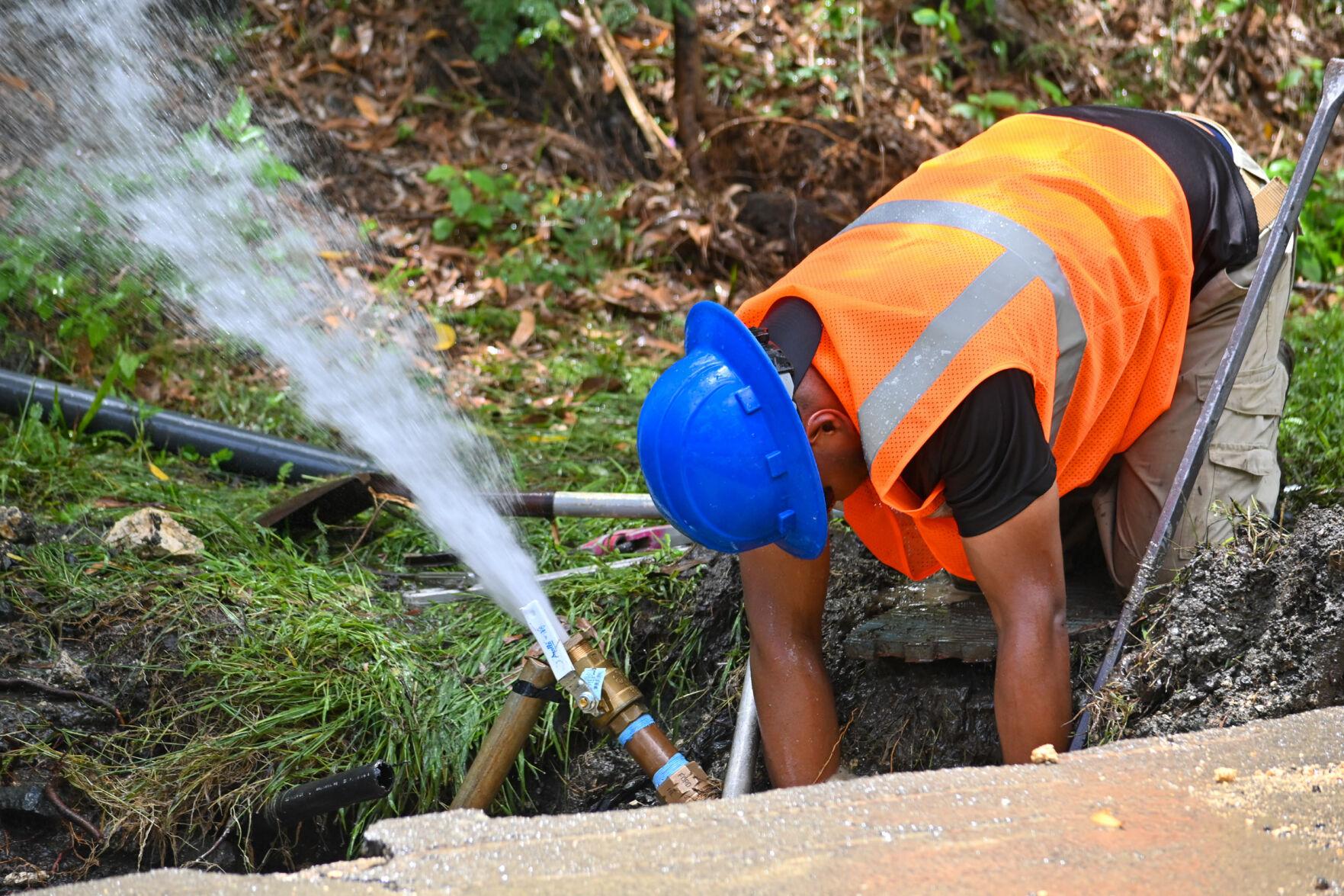 A Guam Waterworks Authority worker attempts to repair a broken water line along Rte. 2 on April 12 in Humåtak.