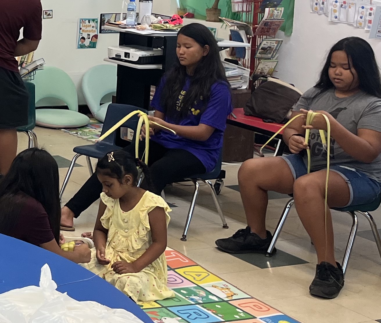 Students of Sinapalo Elementary Chamorro class learn coconut frond weaving on May 15, 2023, in Rota in celebration of Marianas Tourism Month. The class was organized by the Marianas Visitors Authority and included teaching on the significance of heritage tourism.