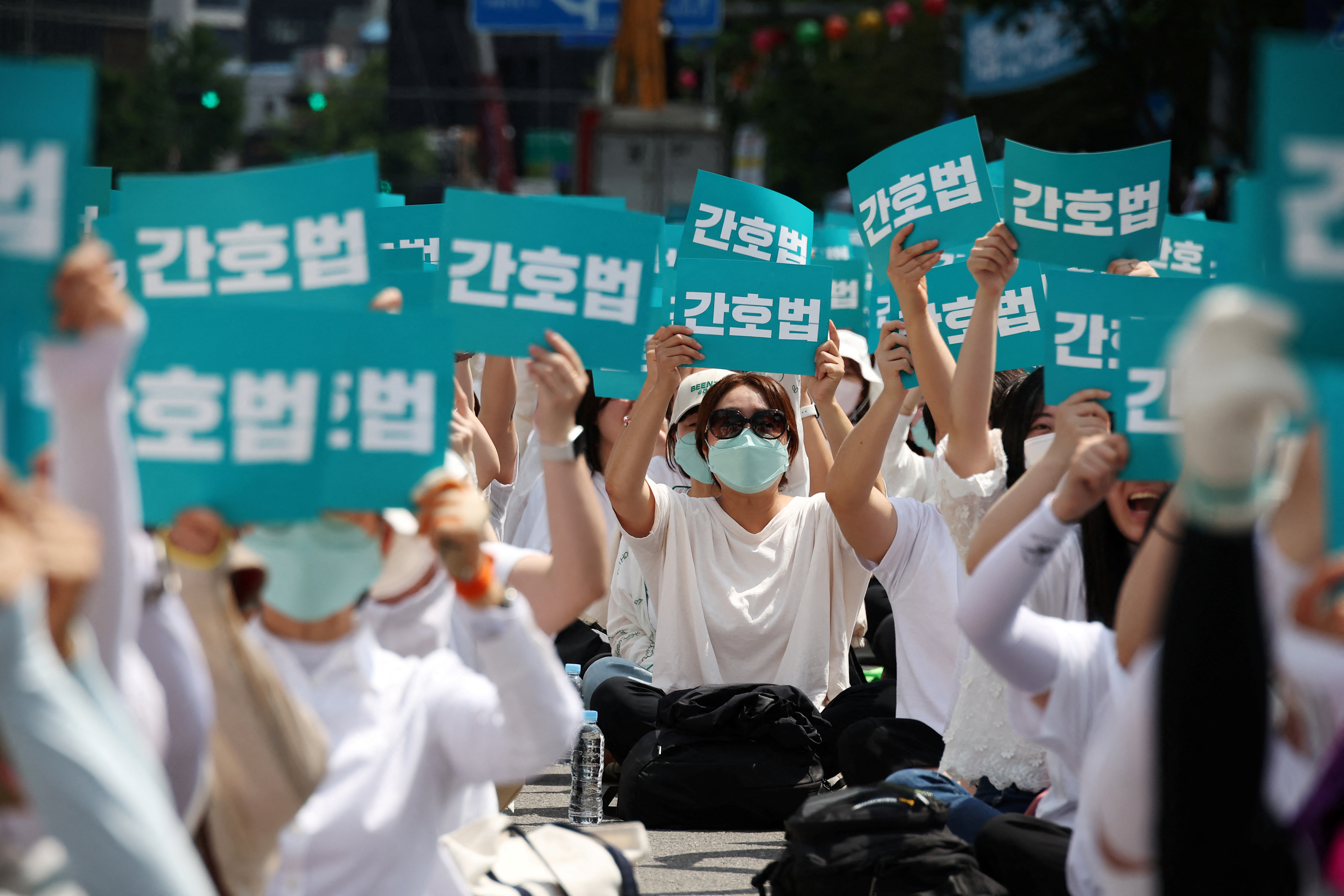 Nurses and university students majoring in nursing chant slogans, as they hold placards that read "Nurse act", during a protest against President Yoon Suk Yeol vetoing a nursing act that defines the roles and responsibilities of nurses, in Seoul, South Korea, May 19, 2023. REUTERS/Kim Hong-Ji