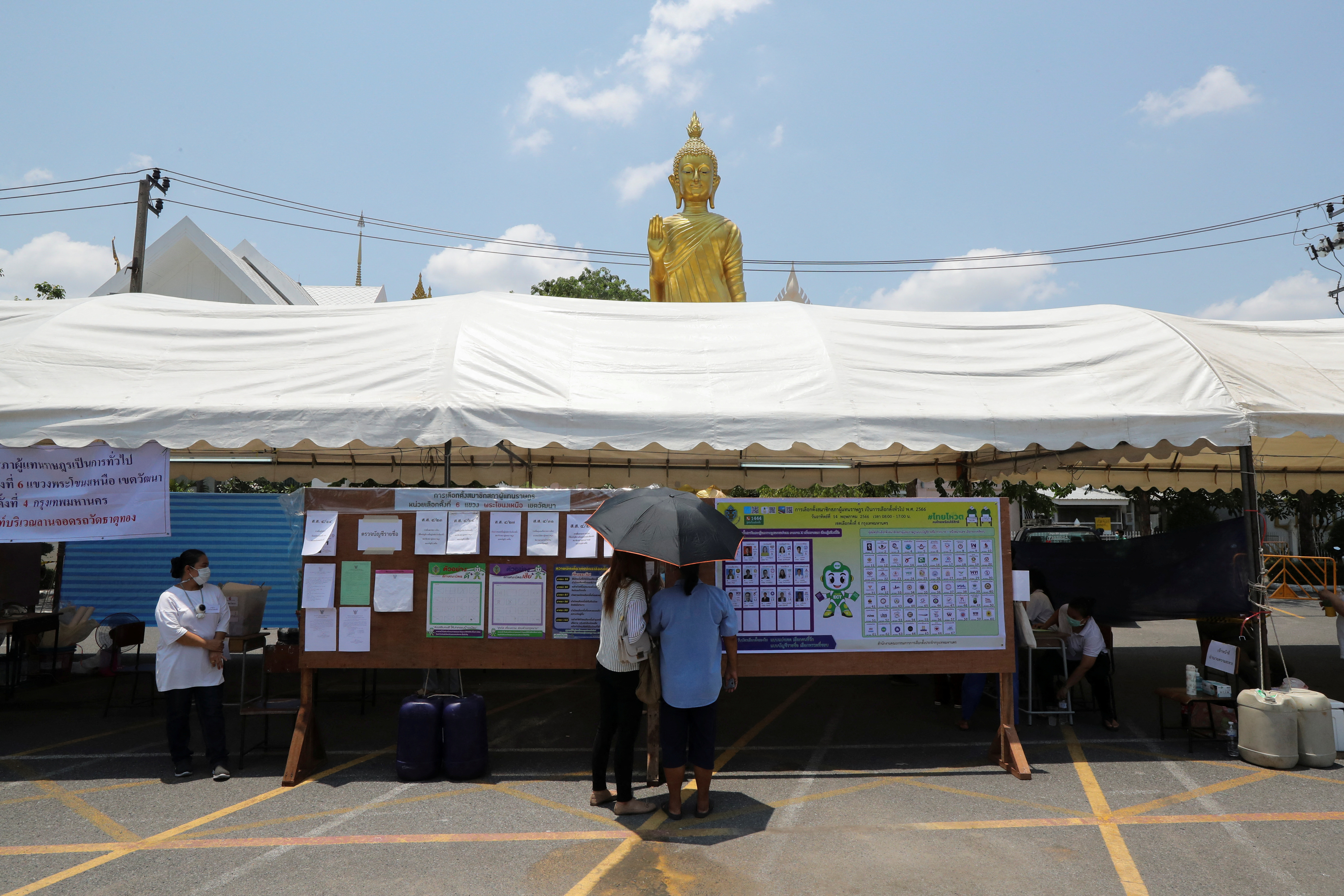 Voters stand outside a polling station during the general election in Bangkok, Thailand, May 14, 2023. REUTERS/Stringer