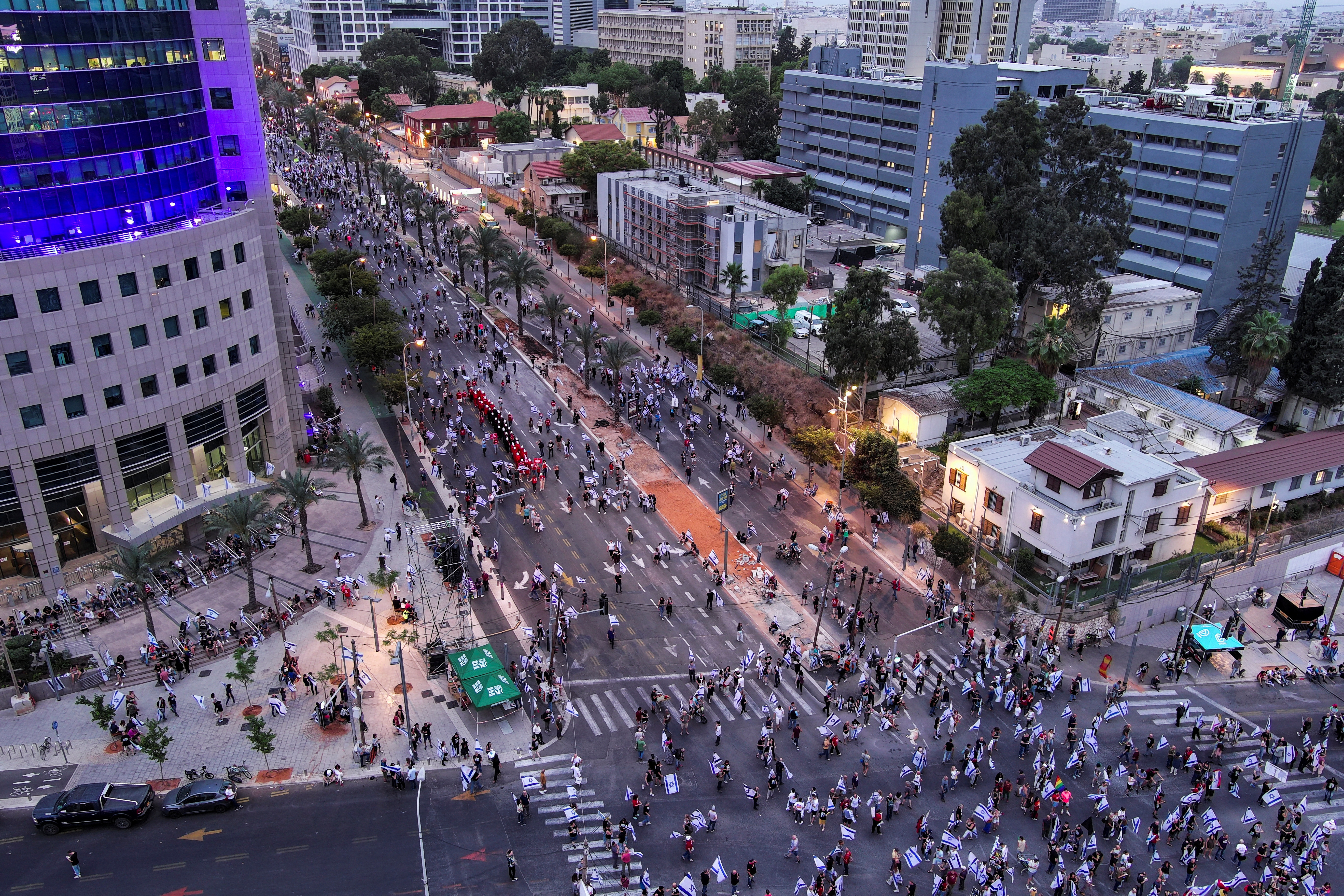 An aerial view shows women dressed as handmaidens from "The Handmaid's Tale" as they take part in a demonstration against Israeli Prime Minister Benjamin Netanyahu and his nationalist coalition government's judicial overhaul, in Tel Aviv, Israel May 27, 2023. REUTERS/Ilan Rosenberg