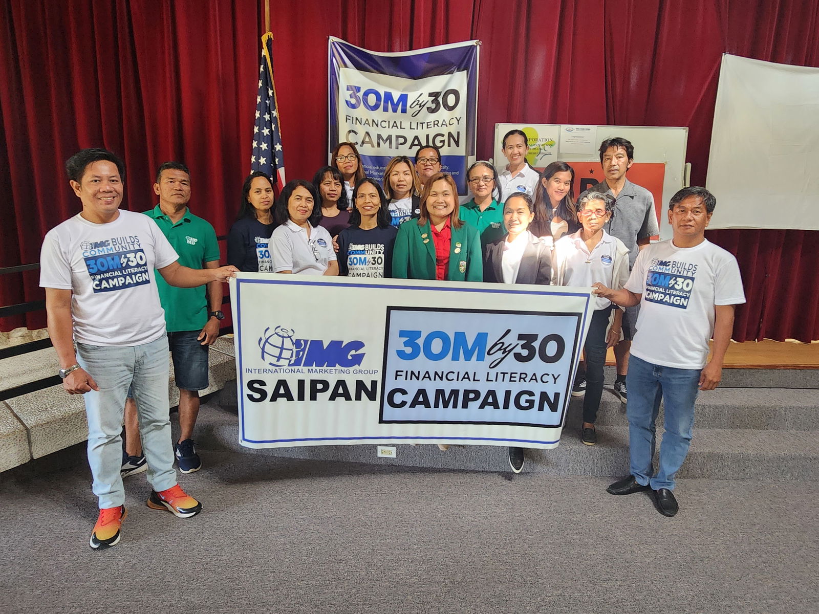 IMG educators and community members pose for a photo during a break from a financial literacy seminar at the multi-purpose center in Susupe on Saturday.