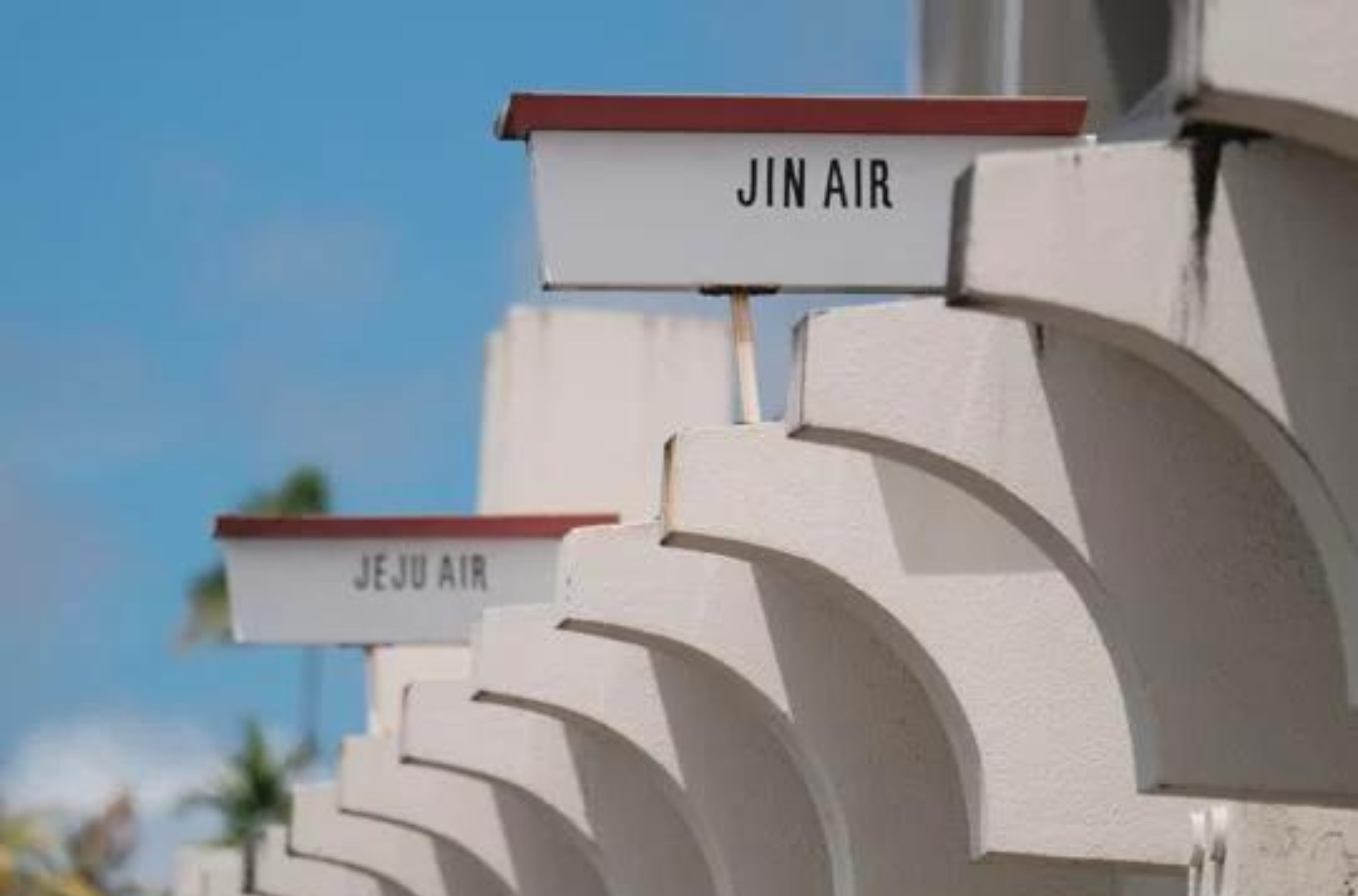 Jin Air and Jeju Air signs are seen at the departure terminal of the Antonio B. Won Pat International Airport in Tamuning on May 10. 
