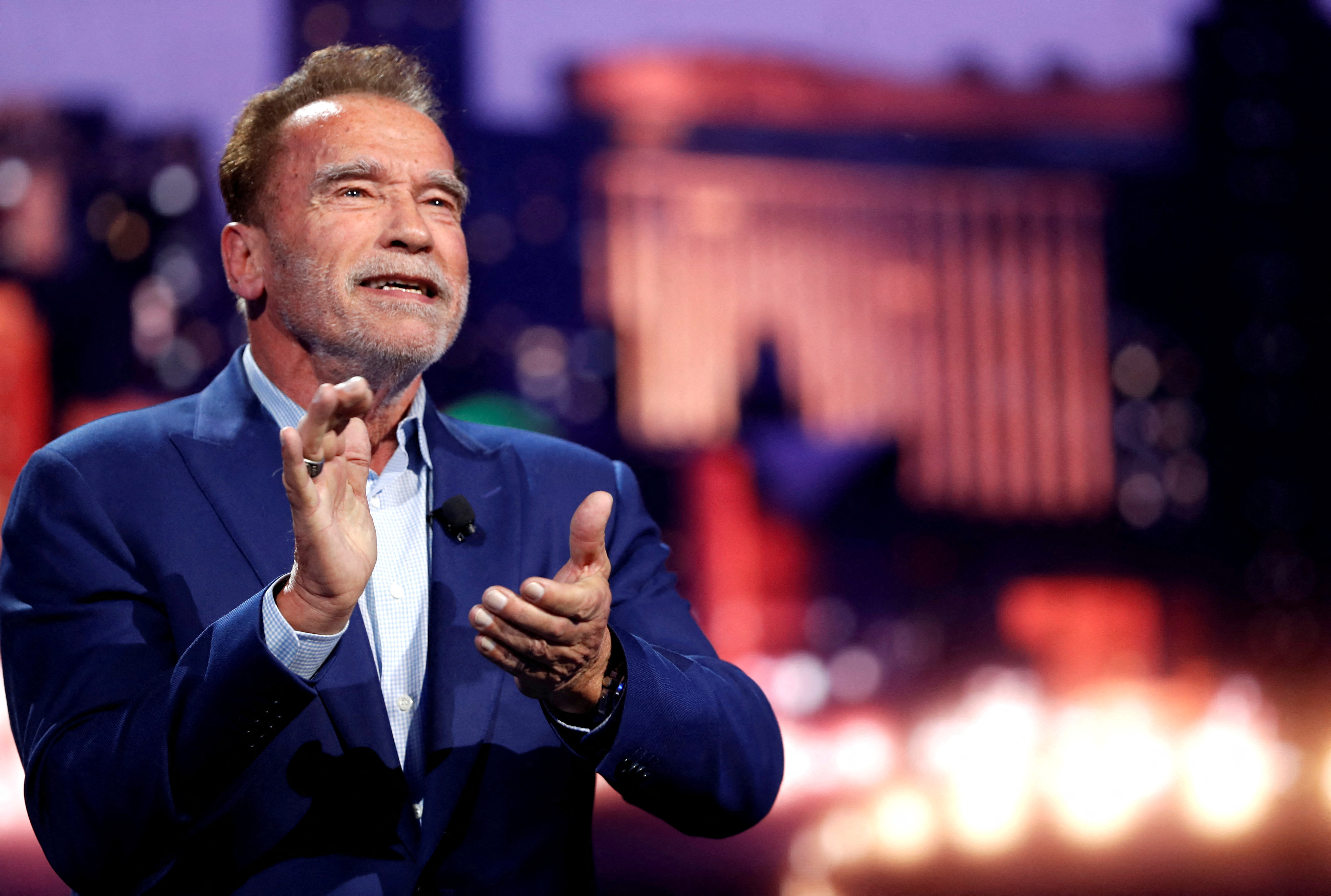Arnold Schwarzenegger, actor and former governor of California, applauds during a BMW keynote address at CES 2023, an annual consumer electronics trade show, in Las Vegas, Nevada, Jan. 4, 2023.