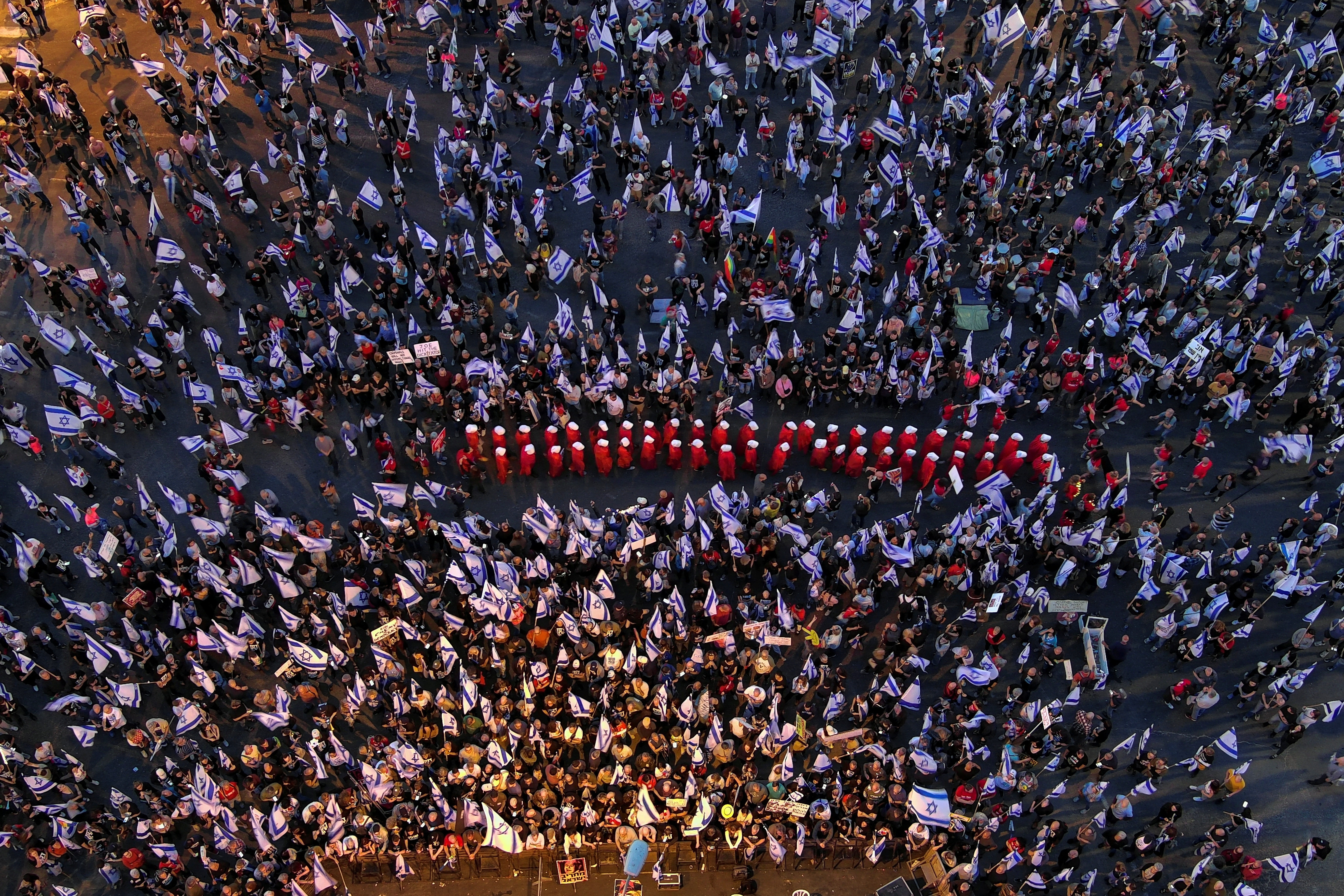 An aerial view shows women dressed as handmaidens from "The Handmaid's Tale", during a demonstration against Israeli Prime Minister Benjamin Netanyahu and his nationalist coalition government's judicial overhaul, in Tel Aviv, Israel May 20, 2023. REUTERS/Ilan Rosenberg